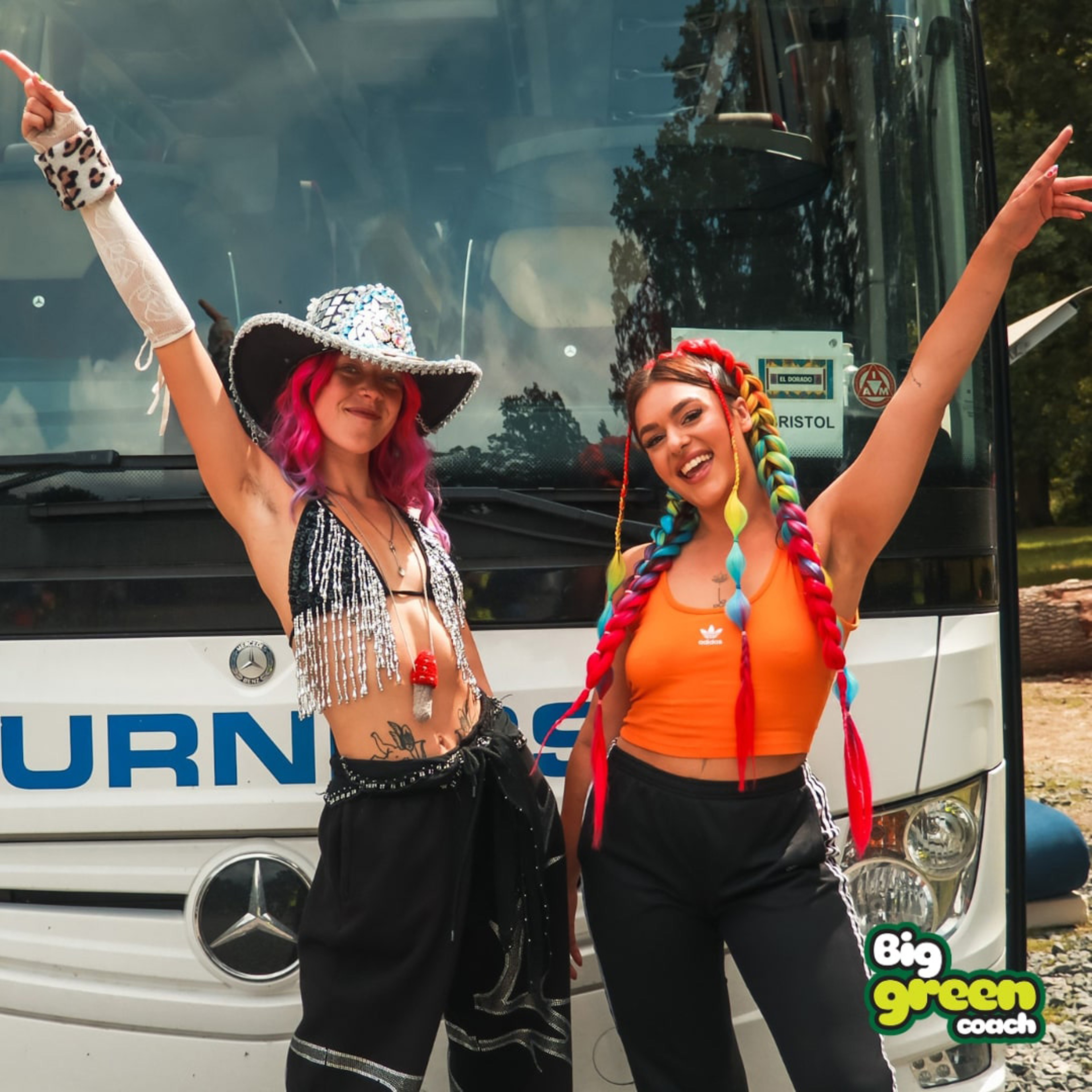 Two women standing in front of coach