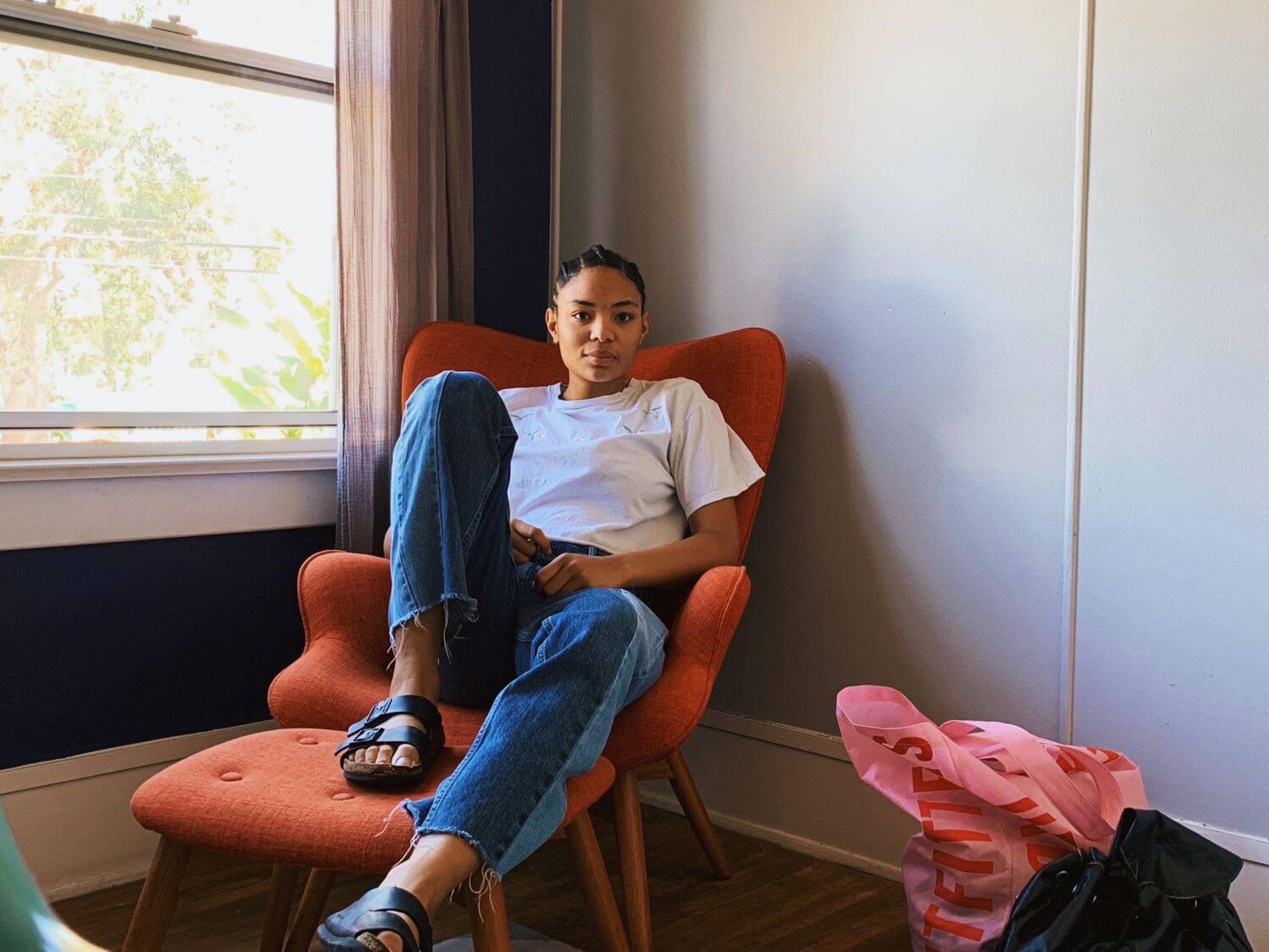 Woman sat on an orange armchair