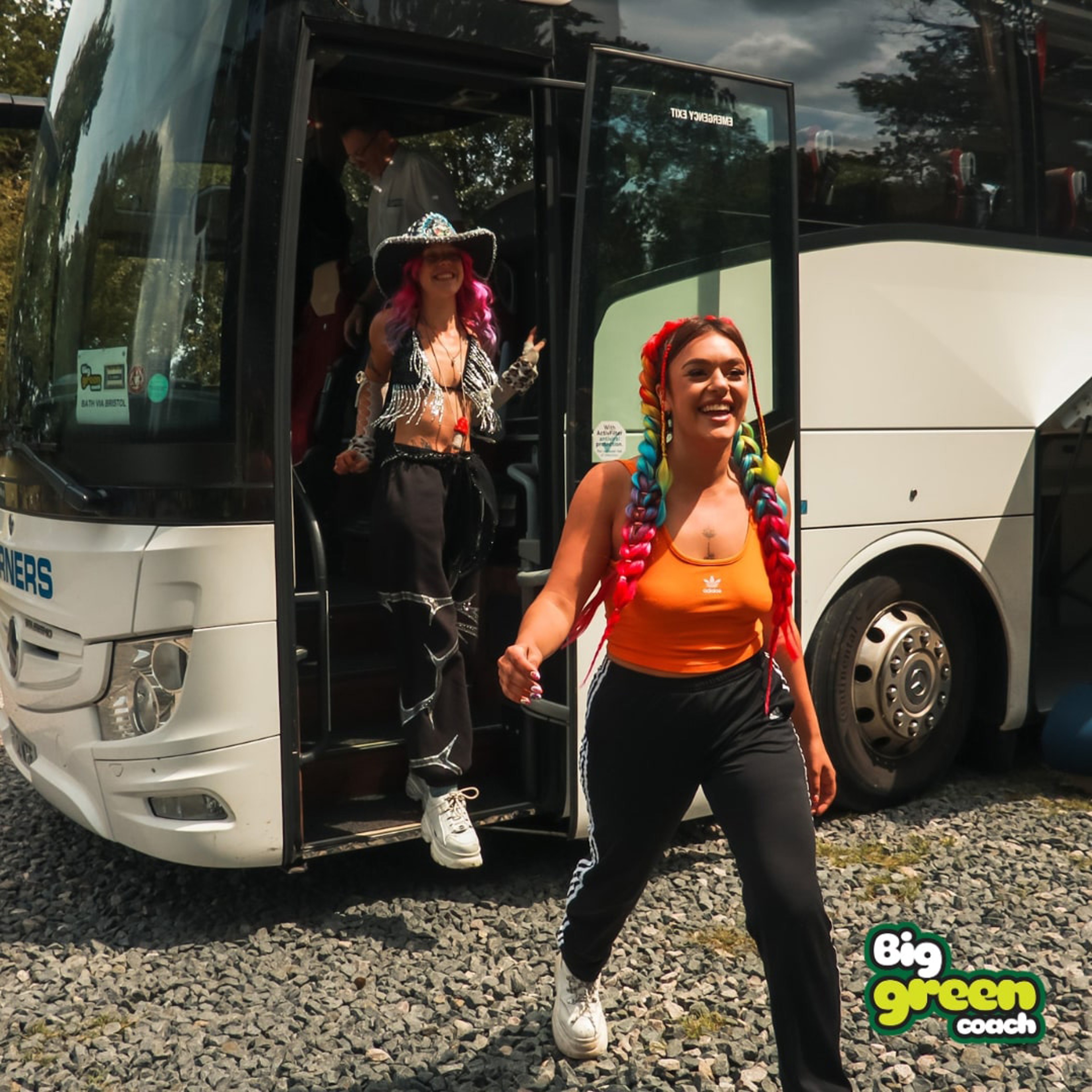 Two women getting off coach