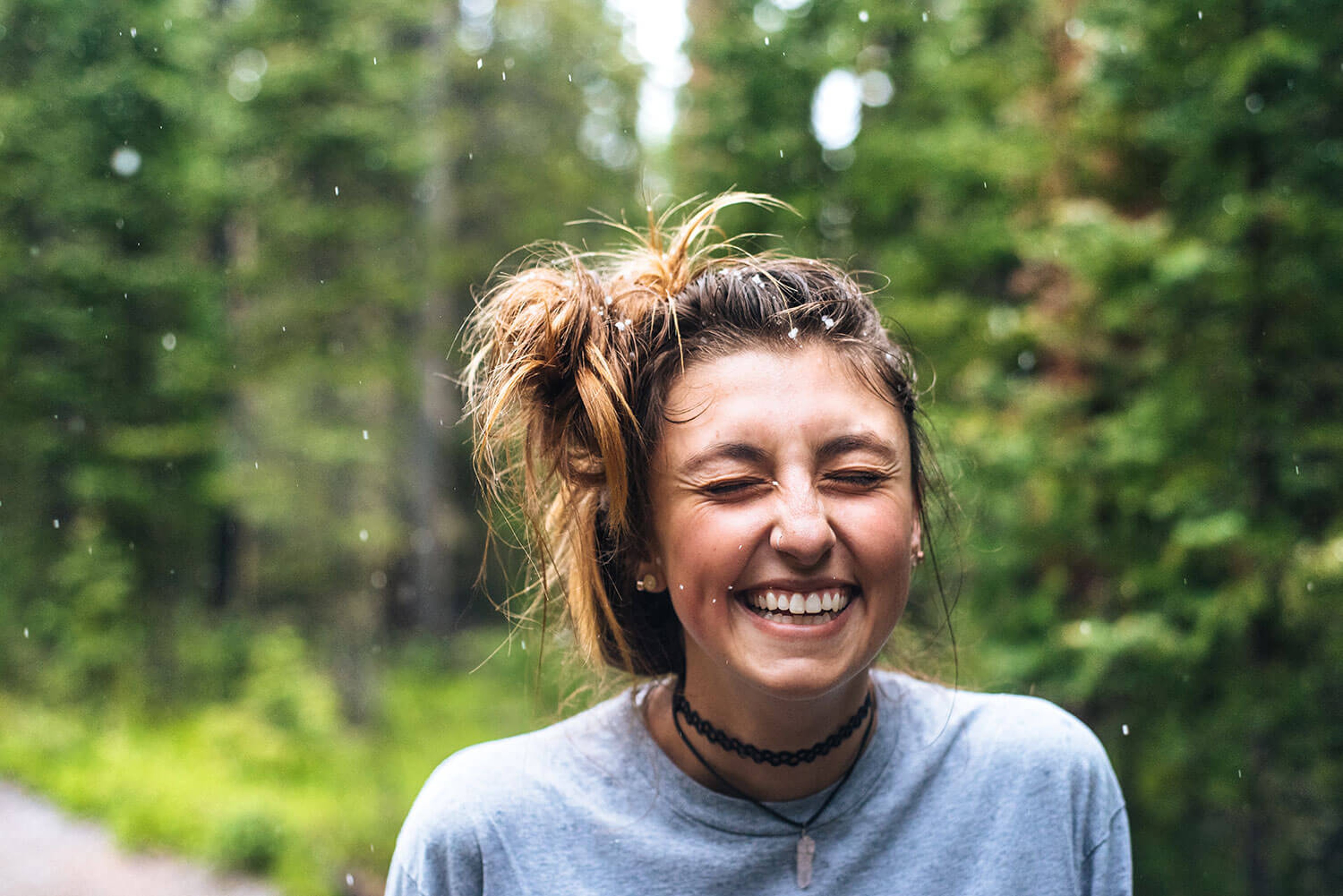 Woman smiling, water splashing