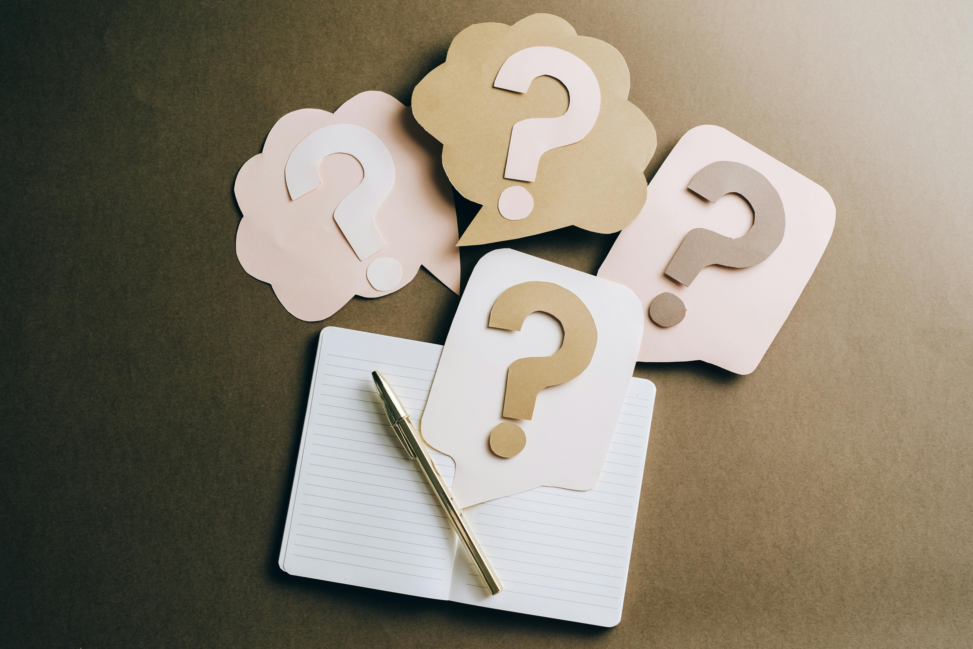 Question marks and notebooks