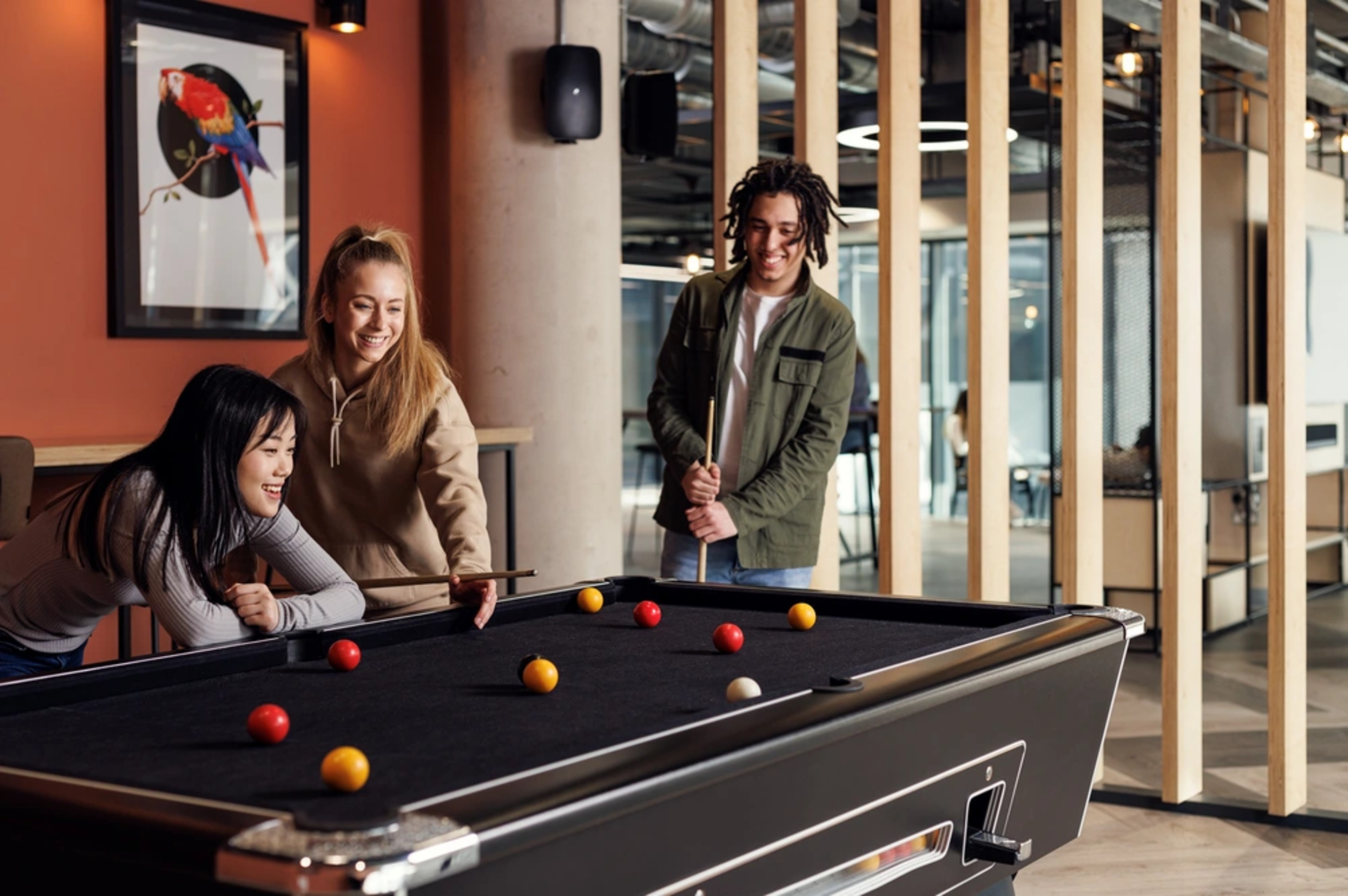 Students playing pool in the common area