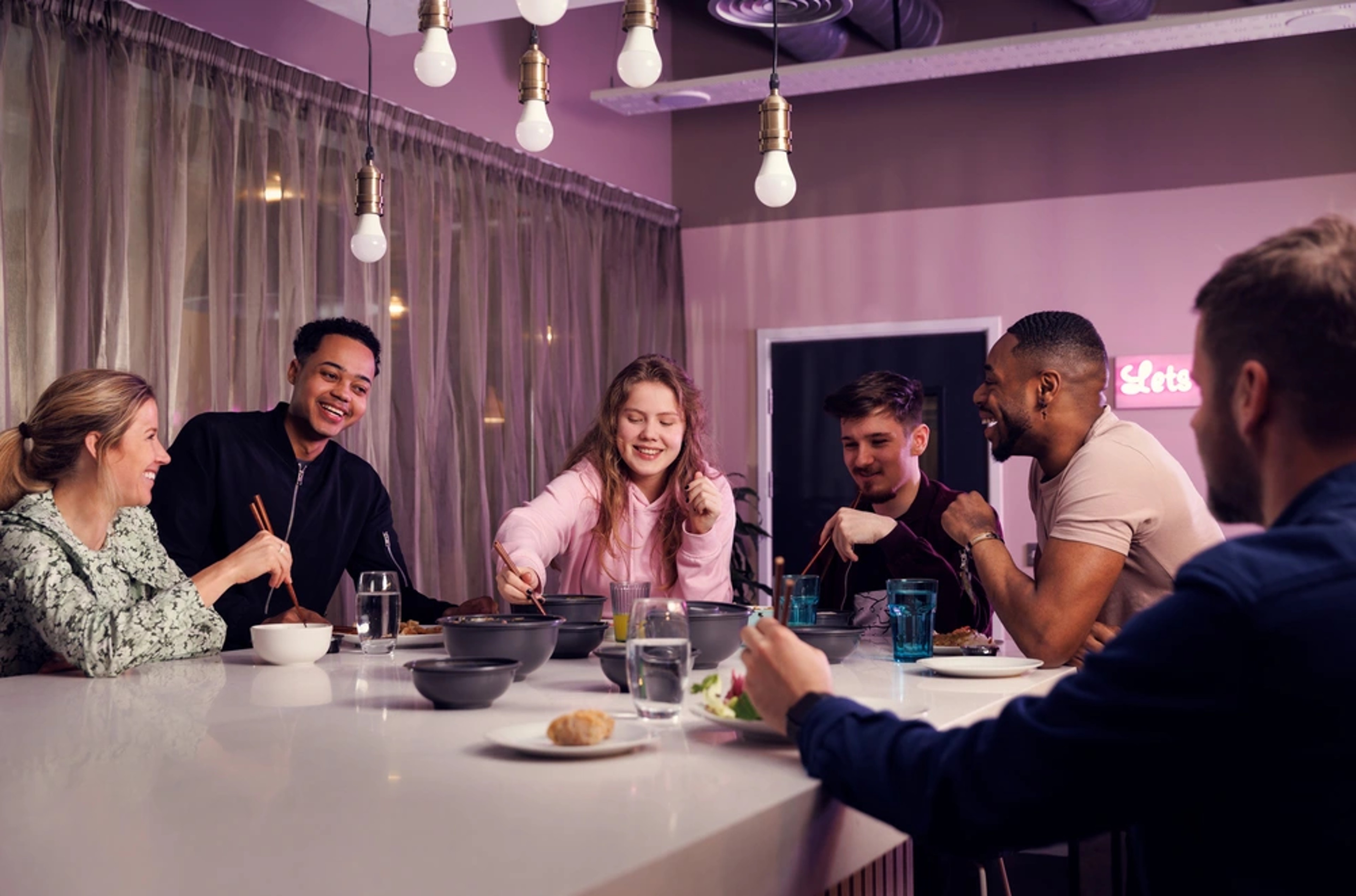 Students sharing food around a table