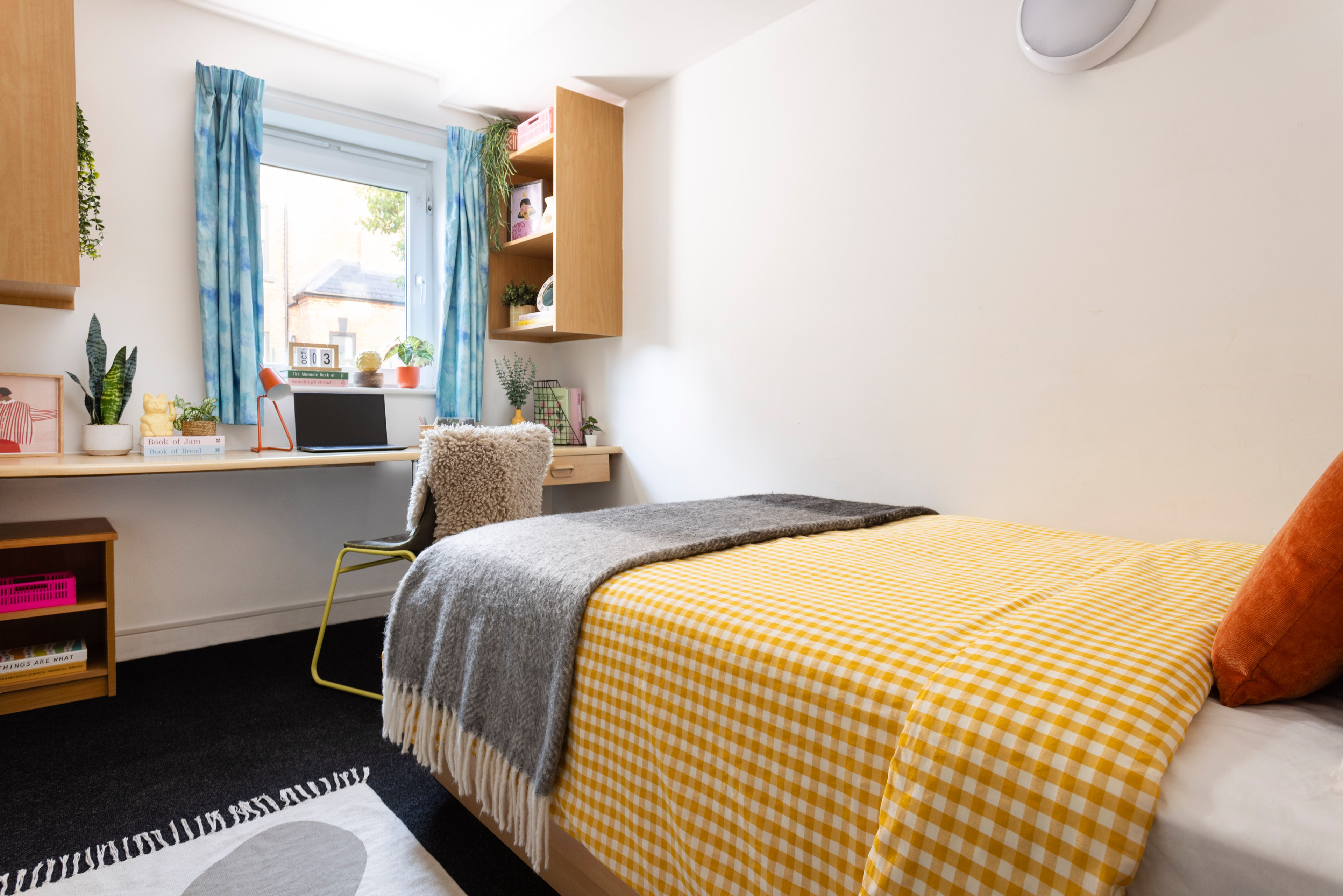 Bed and study space in an en-suite room