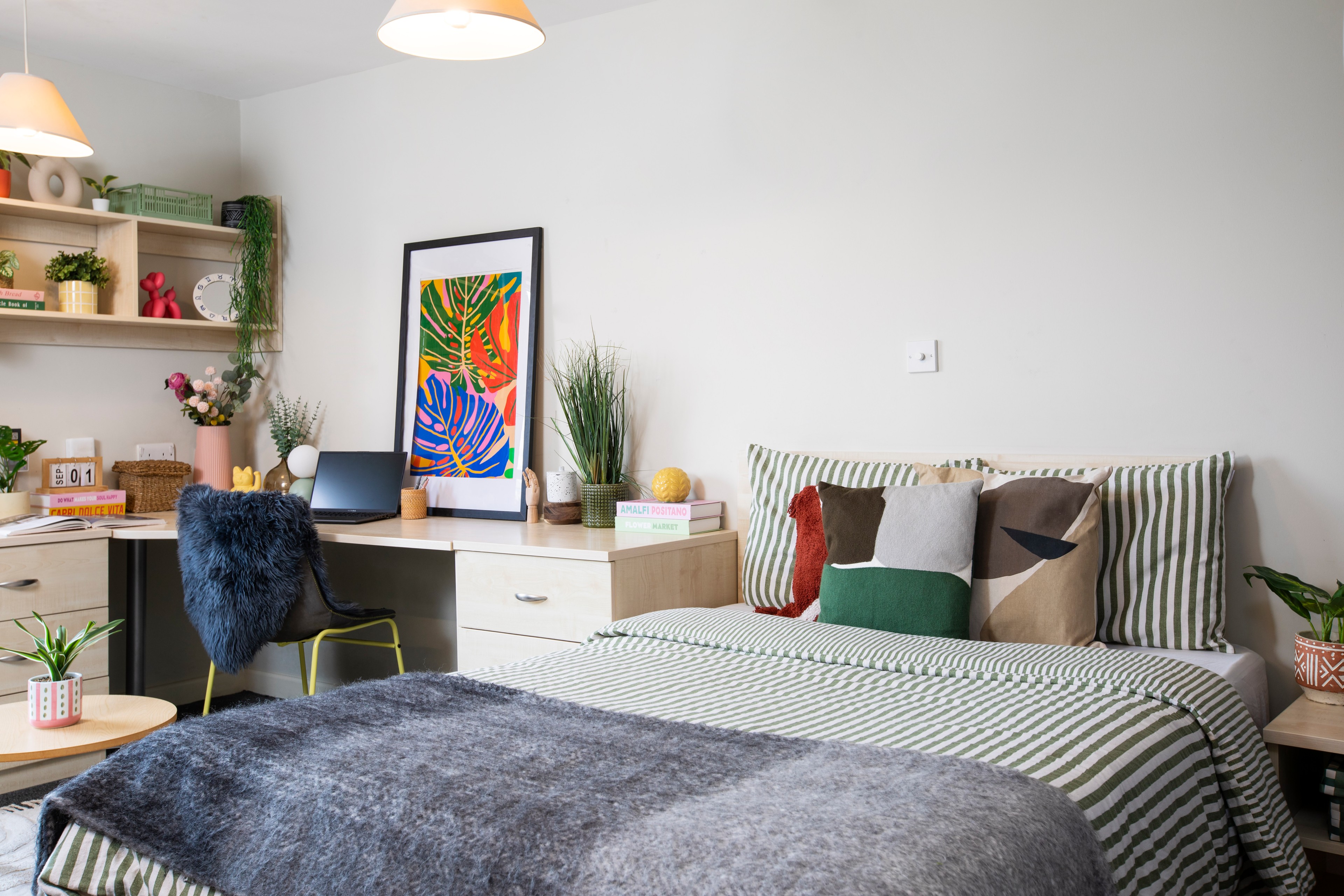 Bed and desk in a studio room