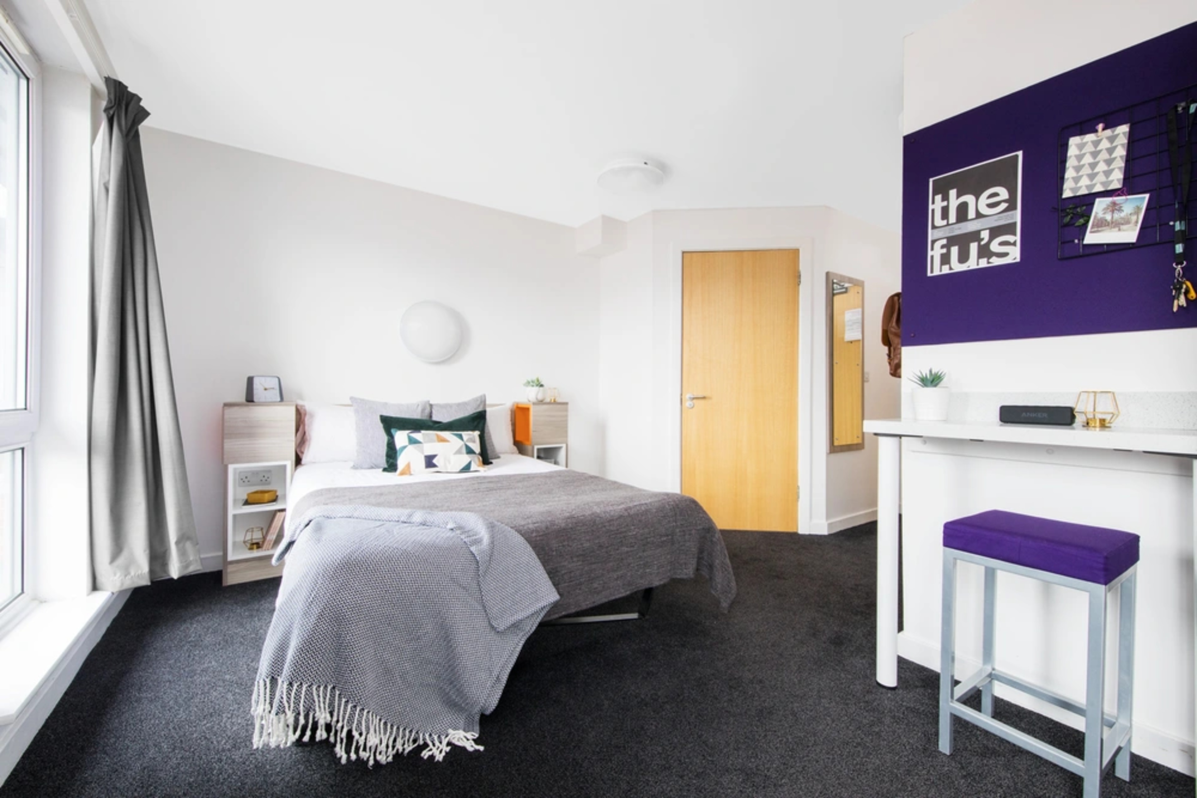 Bed and study space in a Studio