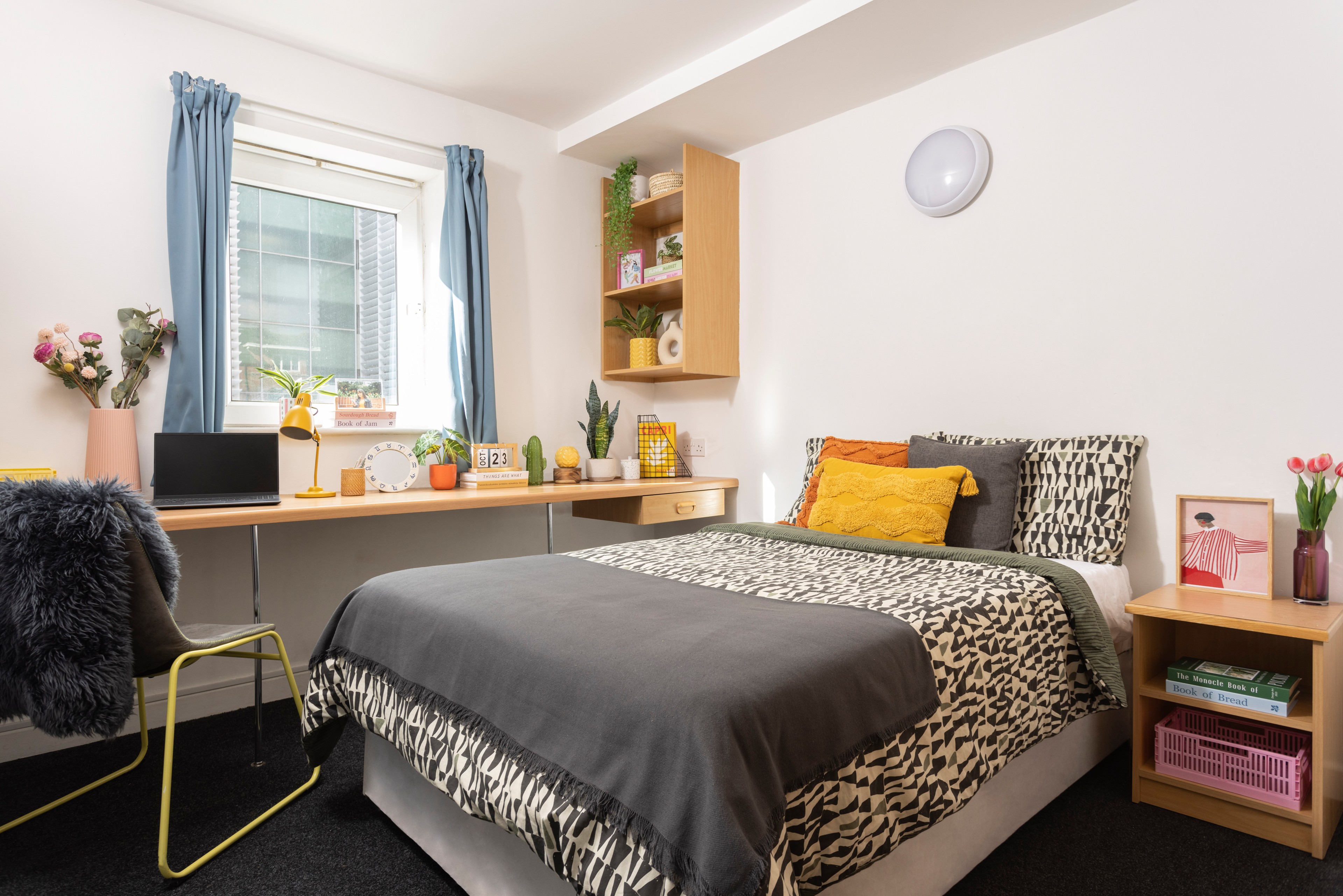 Bed and desk in a premium en-suite room