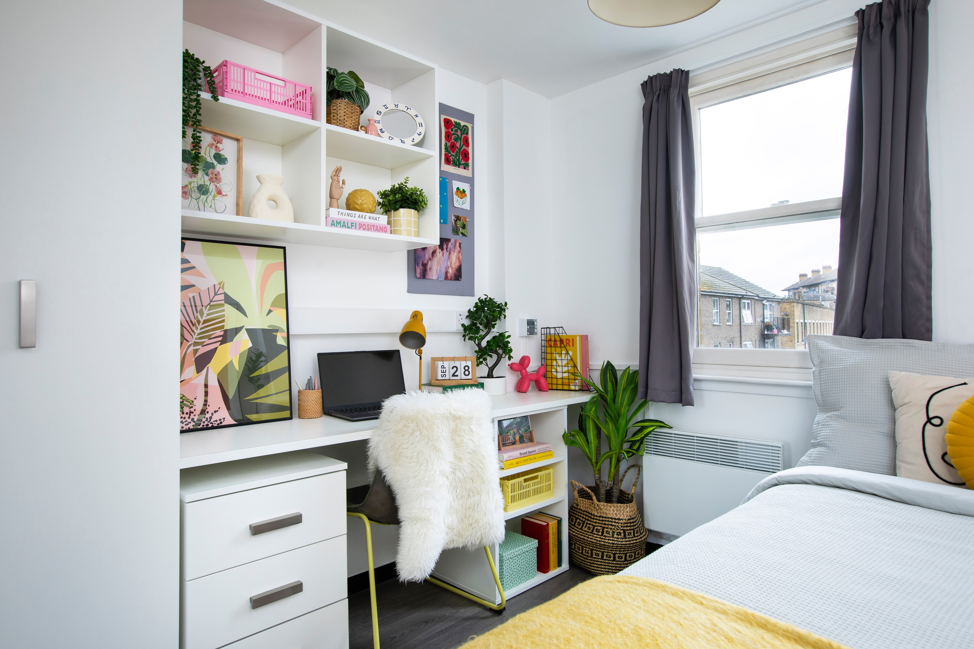 Bed and study space in an en-suite room