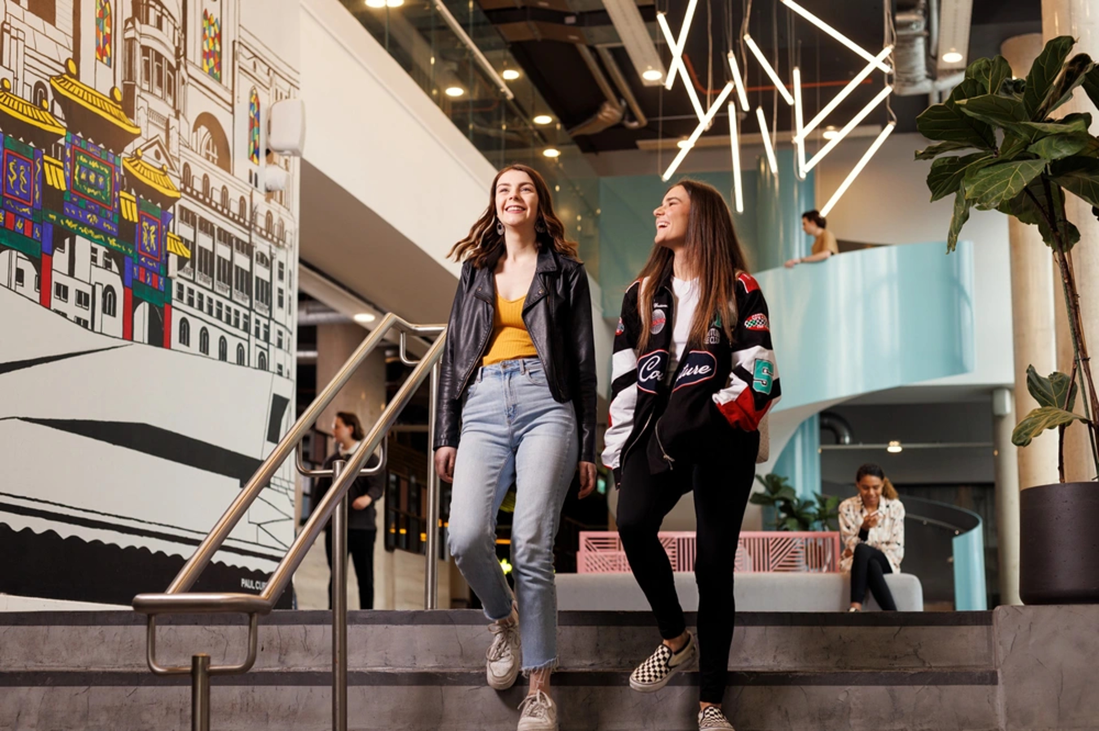 Two students walking down some stairs