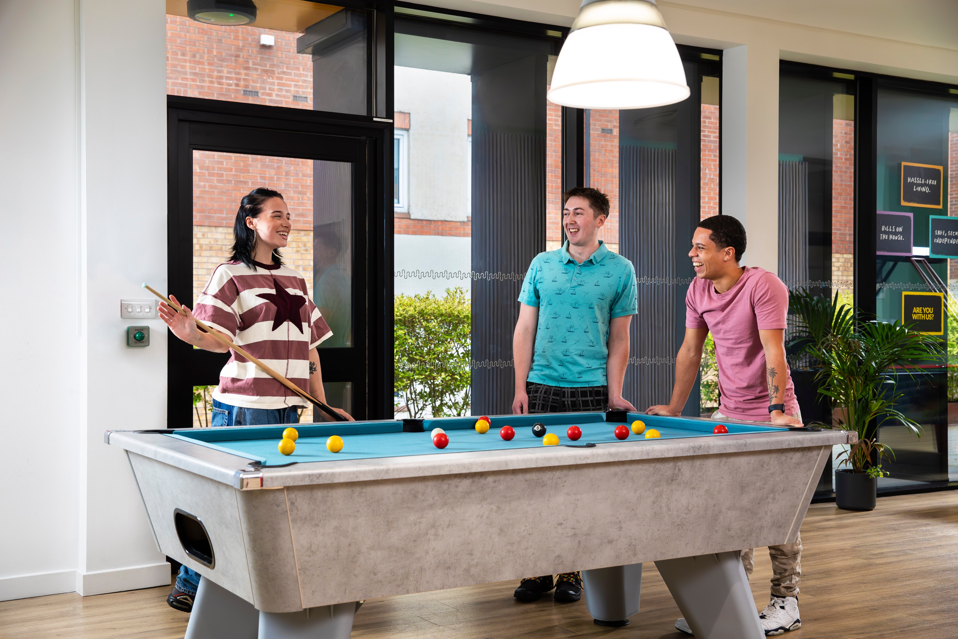 Students playing pool in the game room