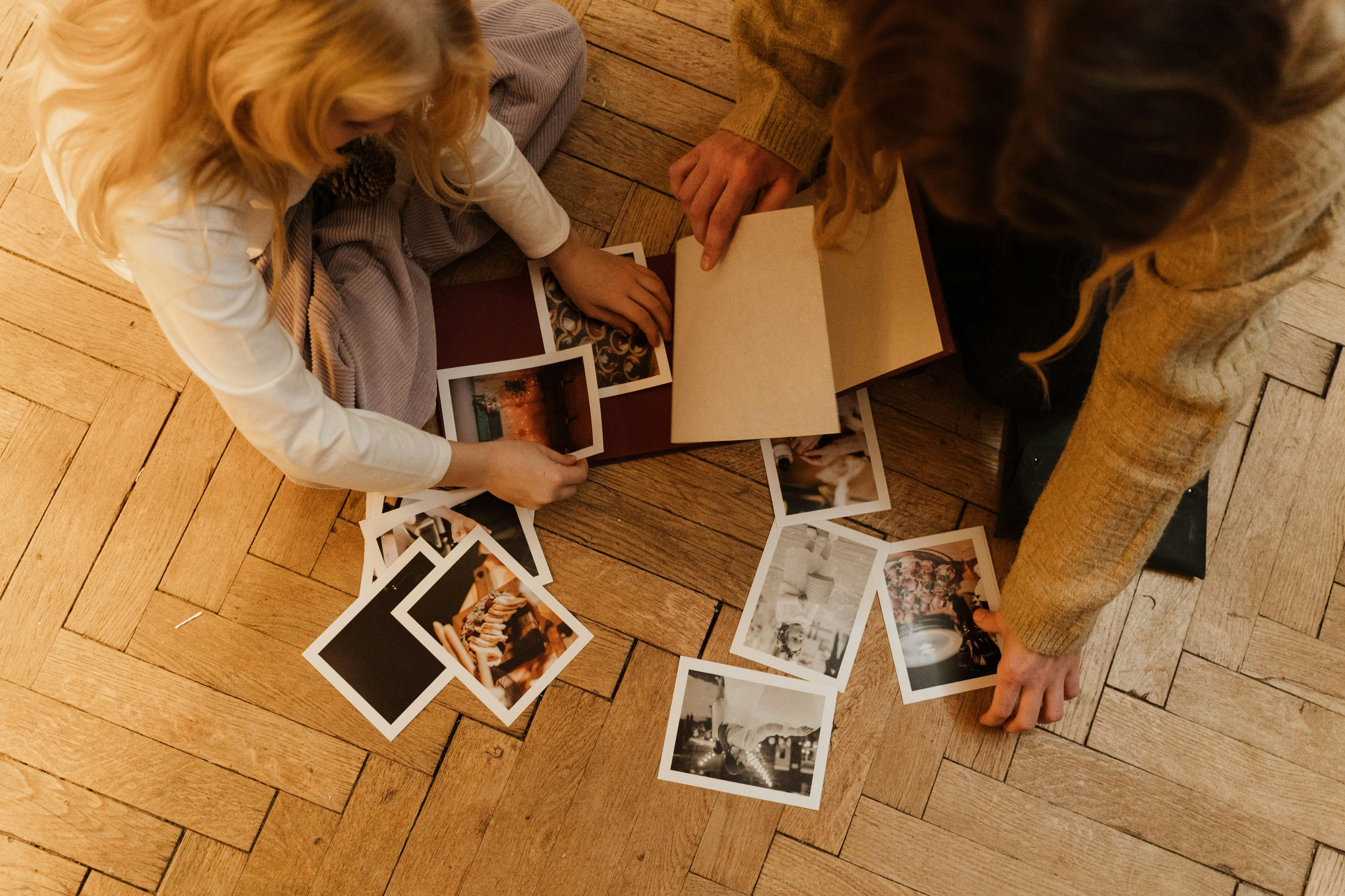 Two friends looking through photographs