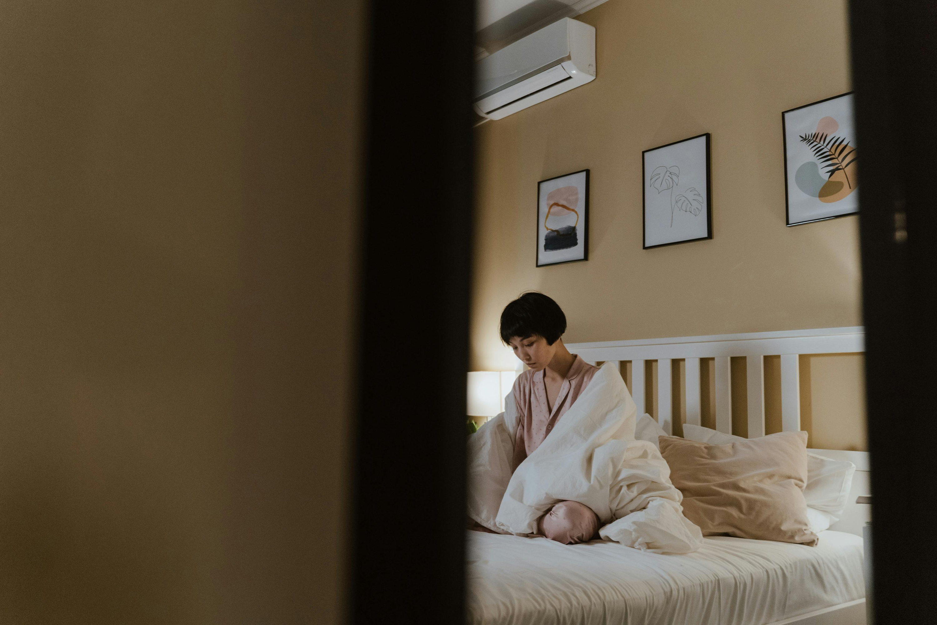 Girl sat on her bed alone