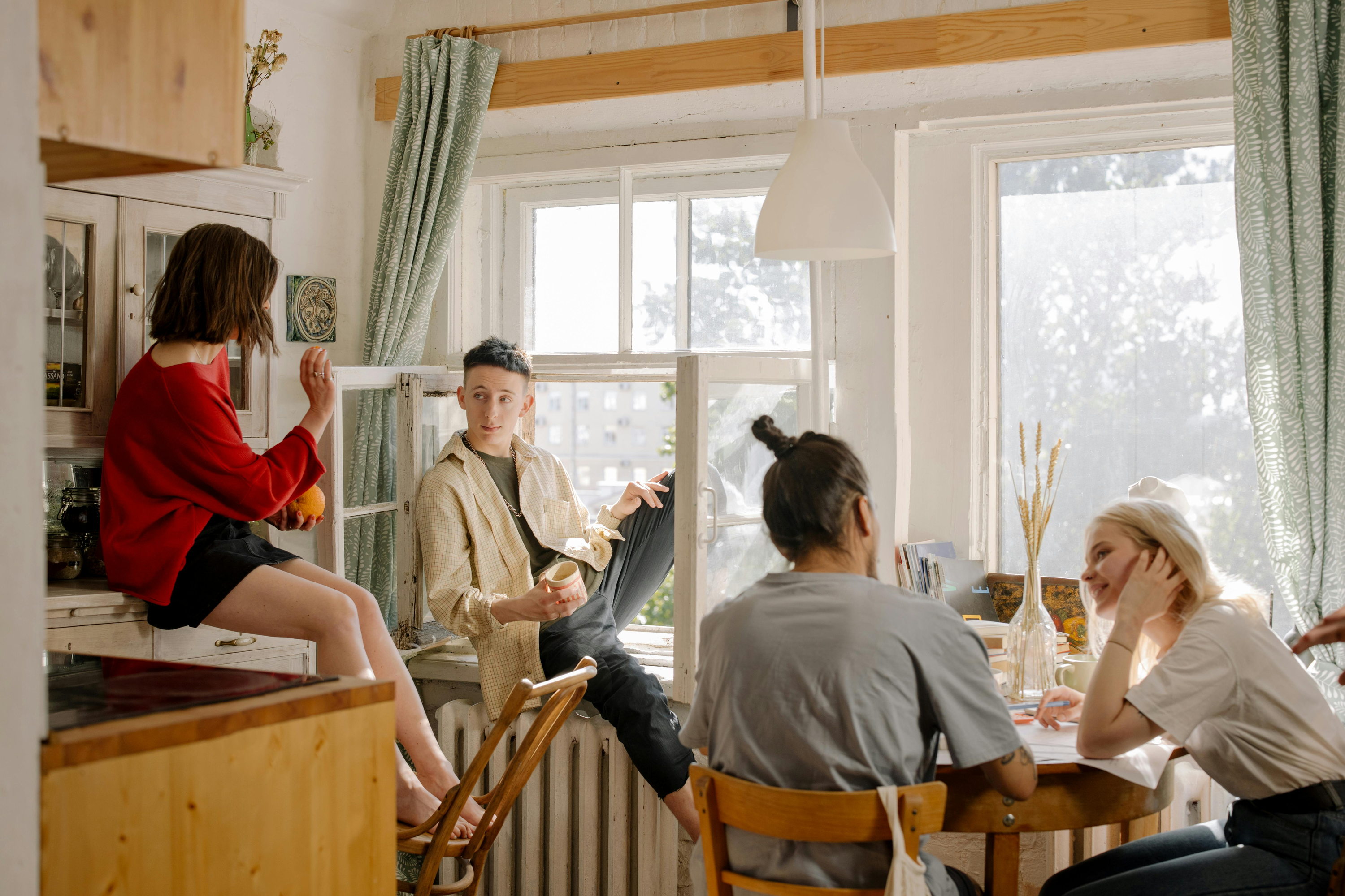 Students sat around in the kitchen