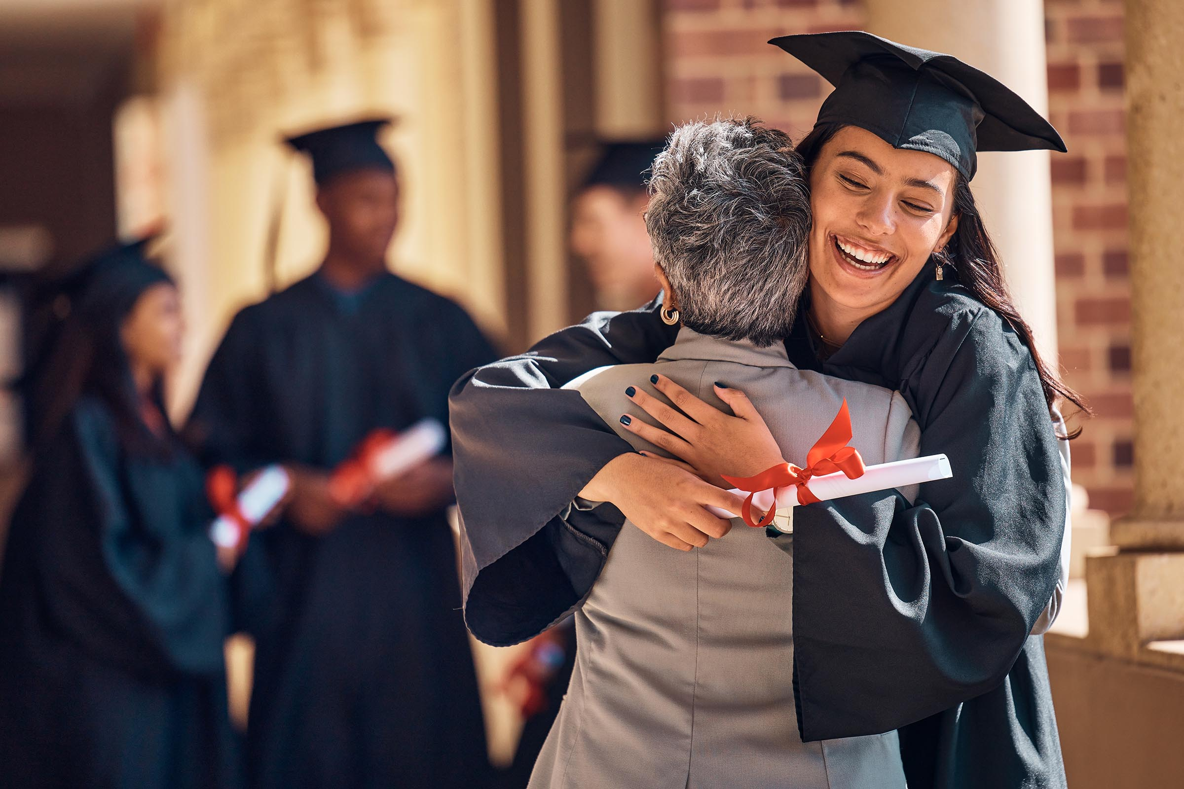 Graduate hugging parent