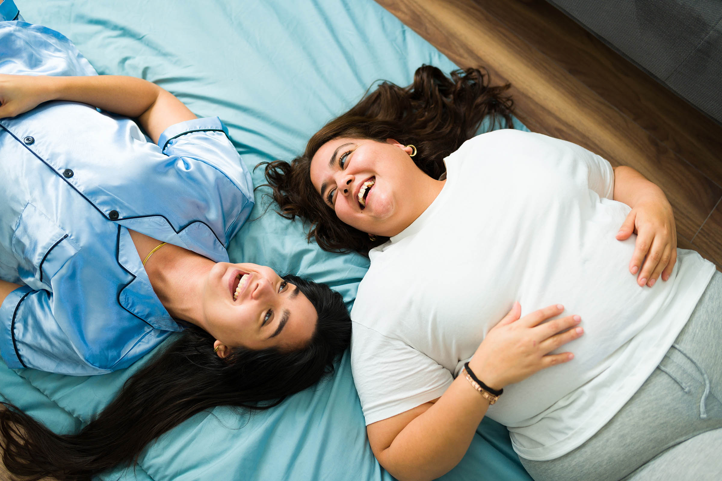 Two friends led on the bed together