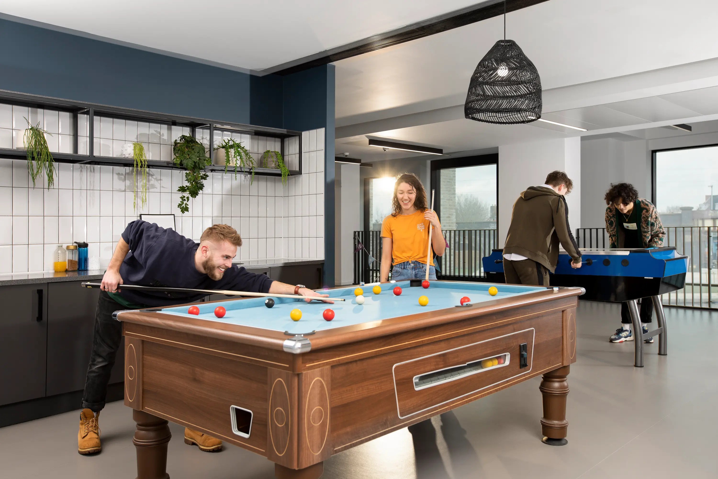 Students playing pool in the games area