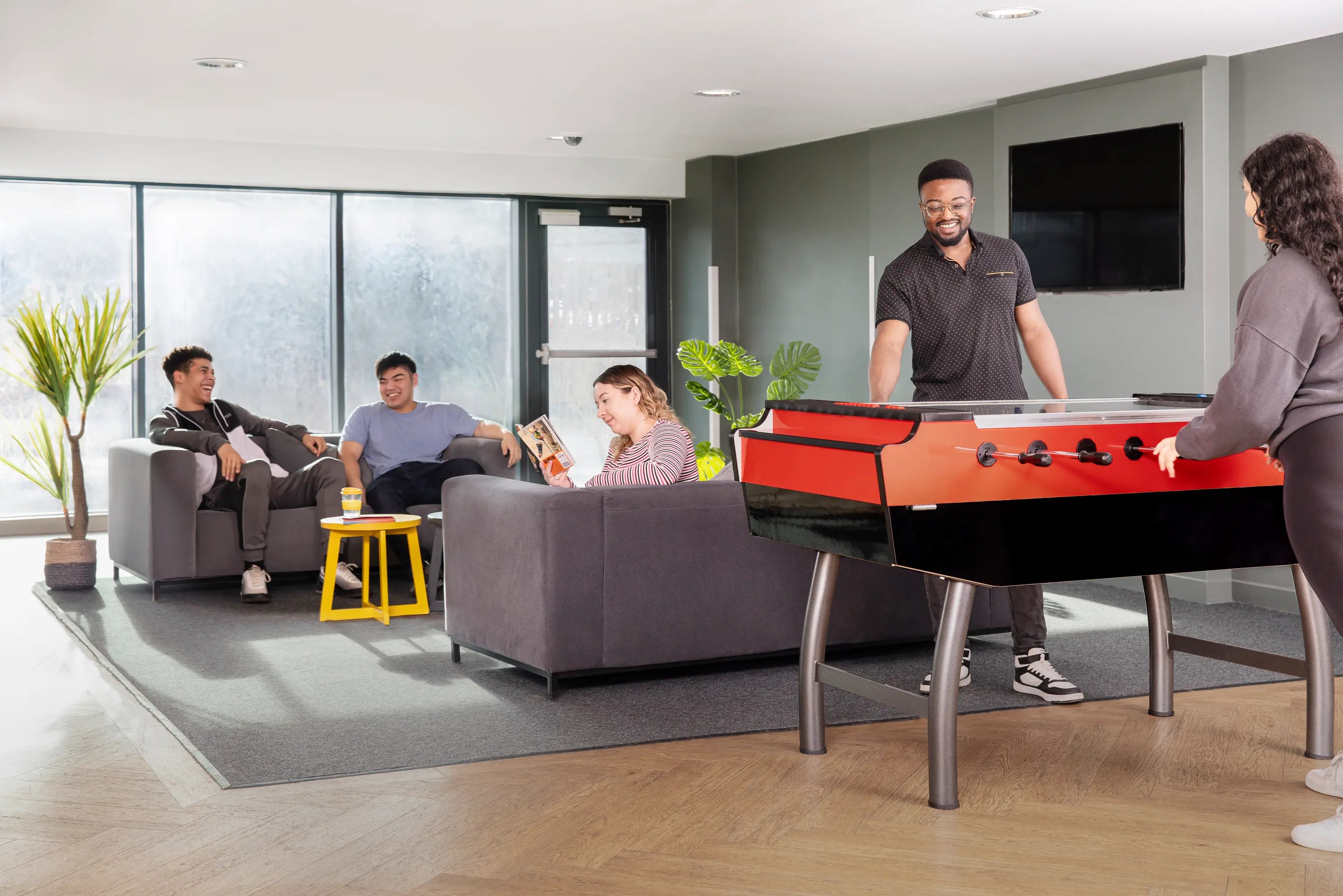 Students playing pool in common room