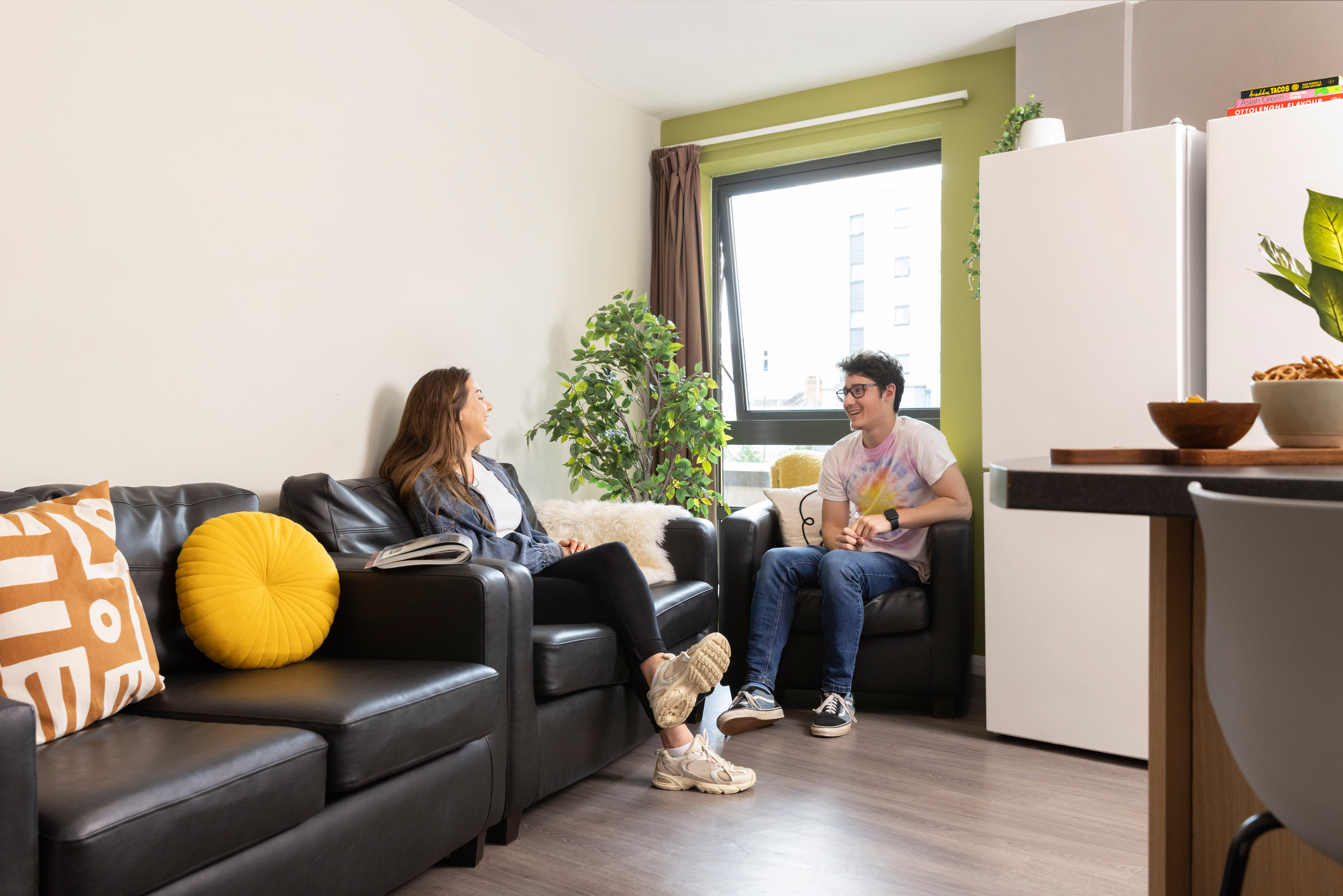 Students on the shared kitchen sofas