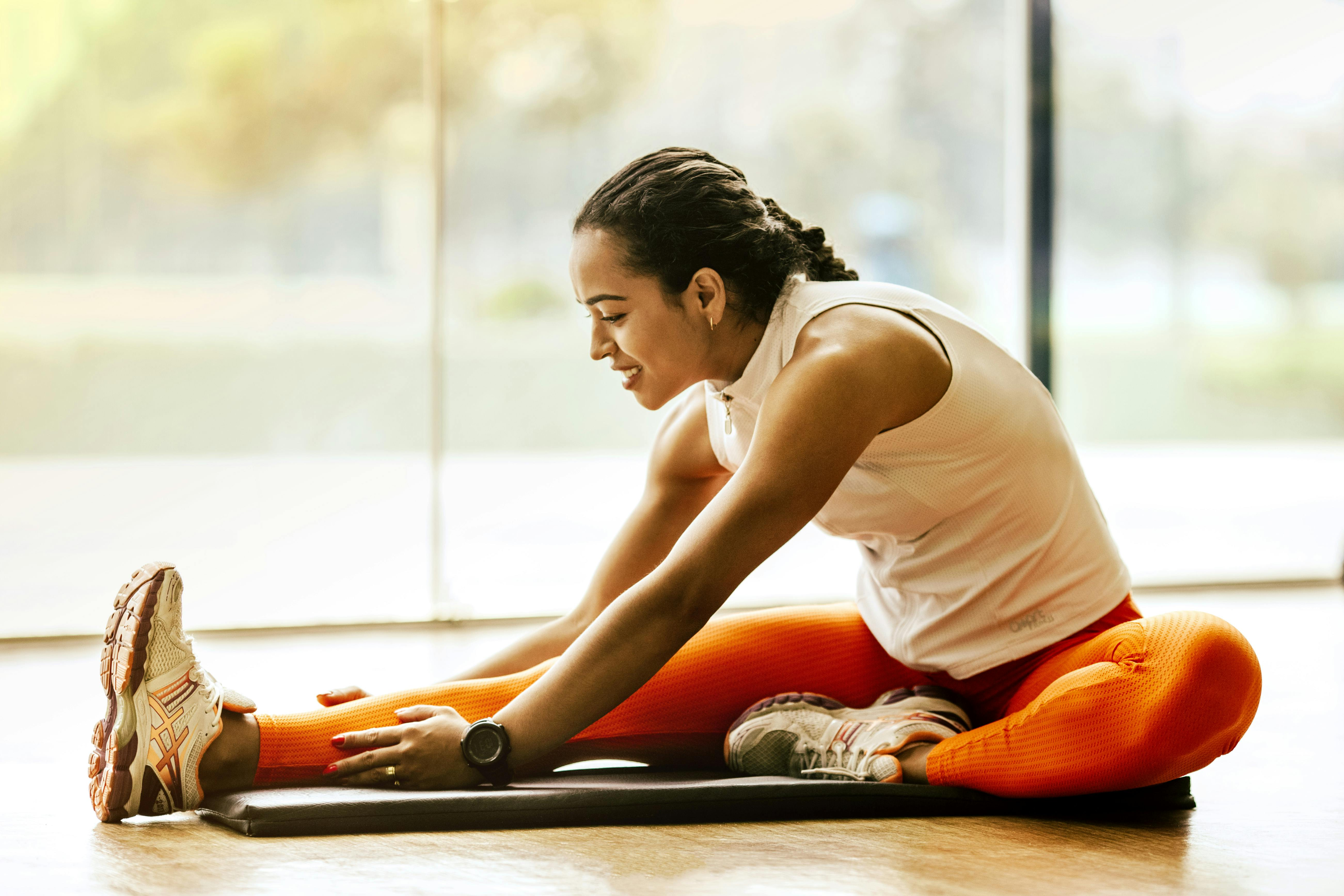 Girl stretching on yoga mat