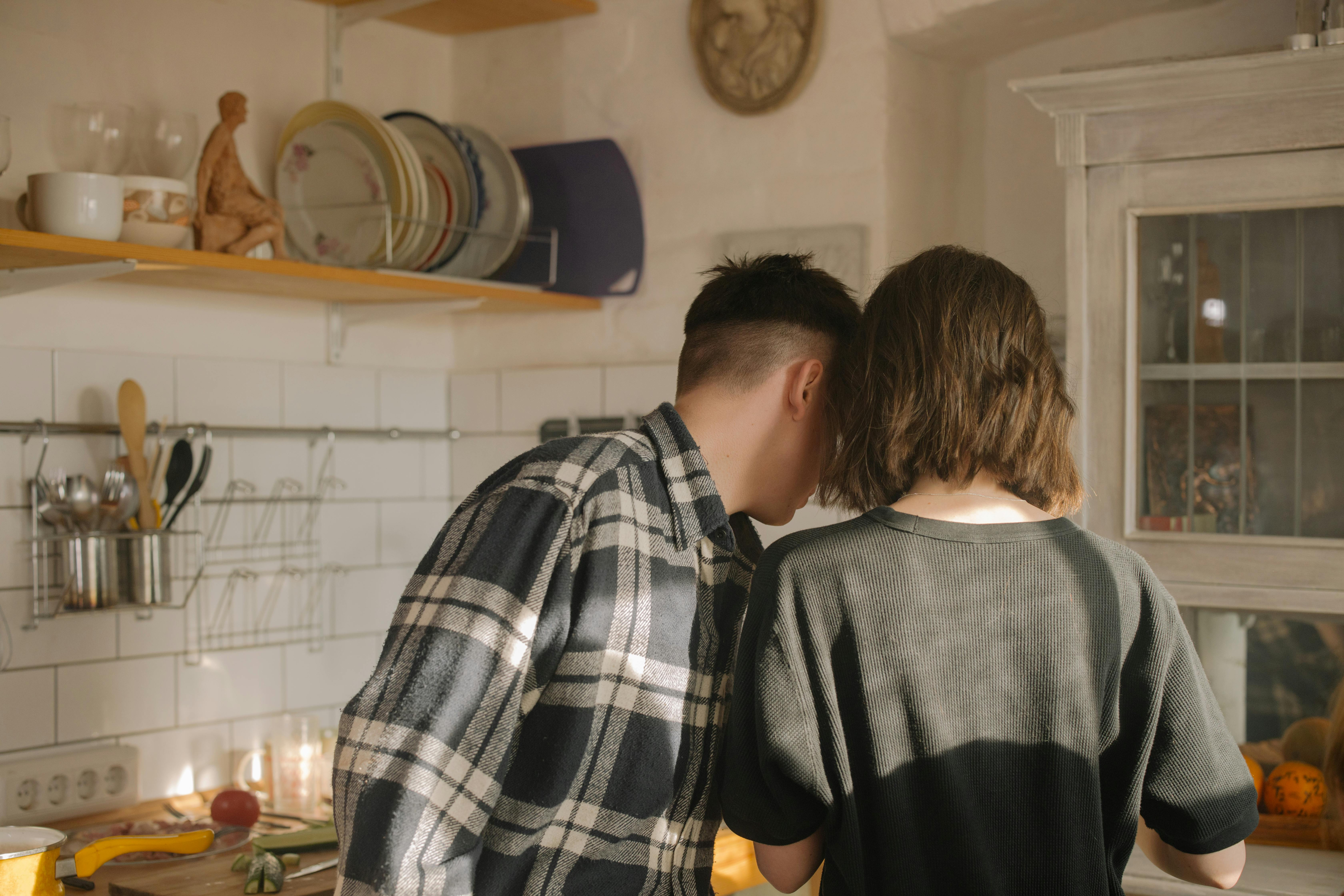 Photo of two people stood in kitchen