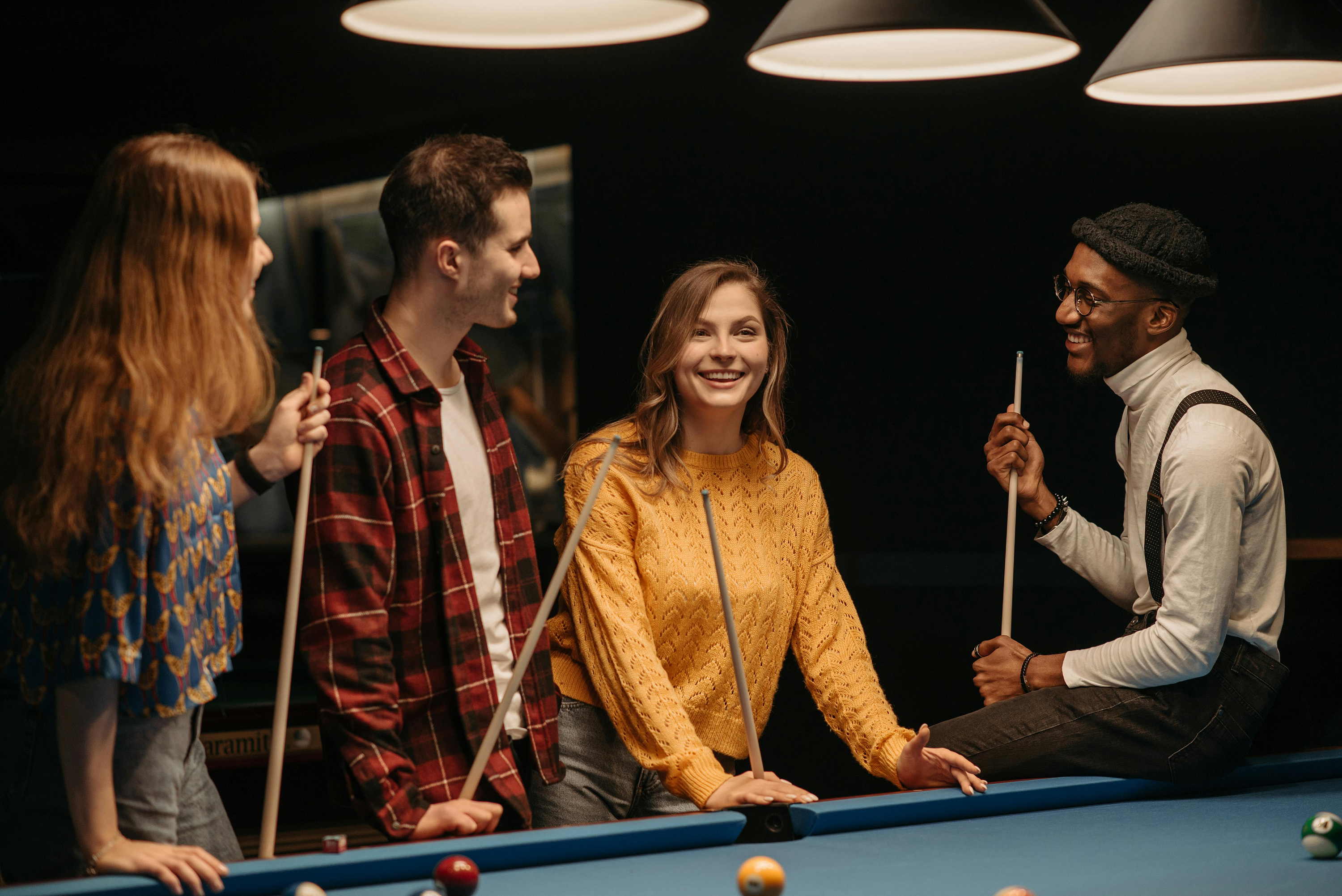 Students stood around a pool table