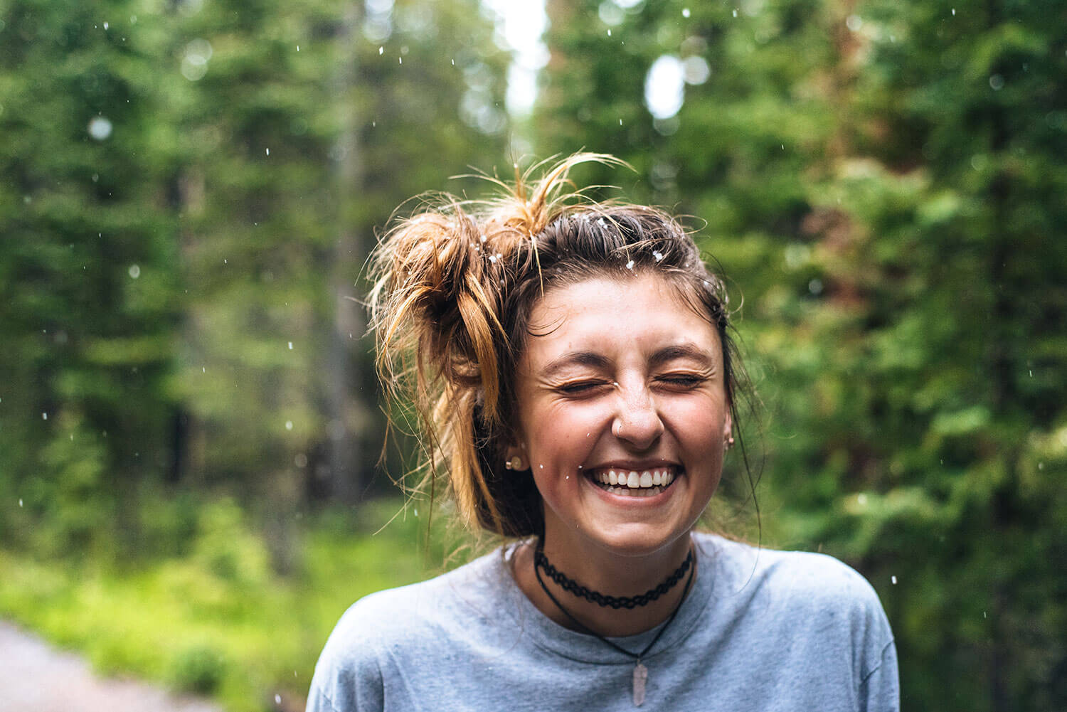 Woman smiling, water splashing