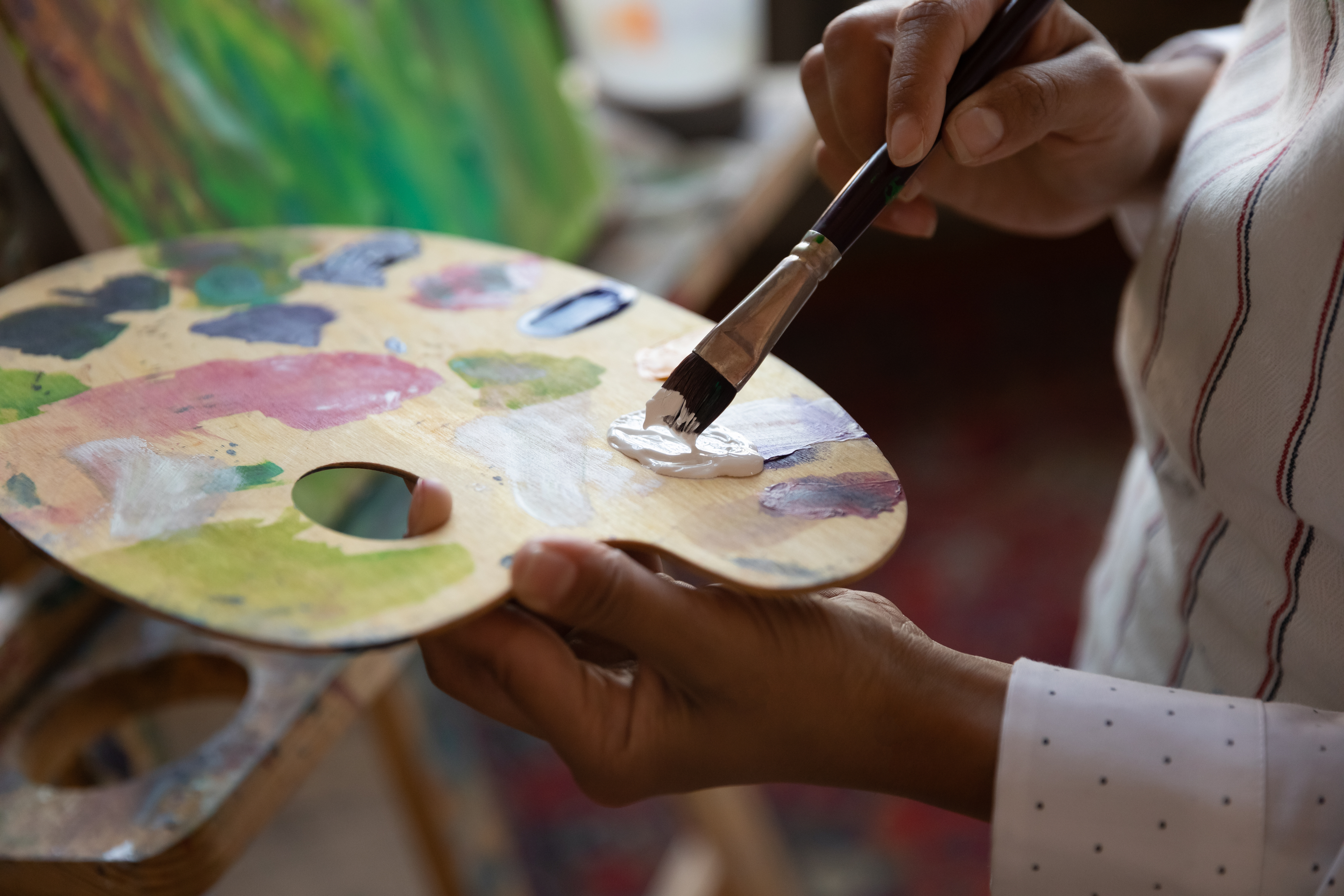 Person holding a paint palette