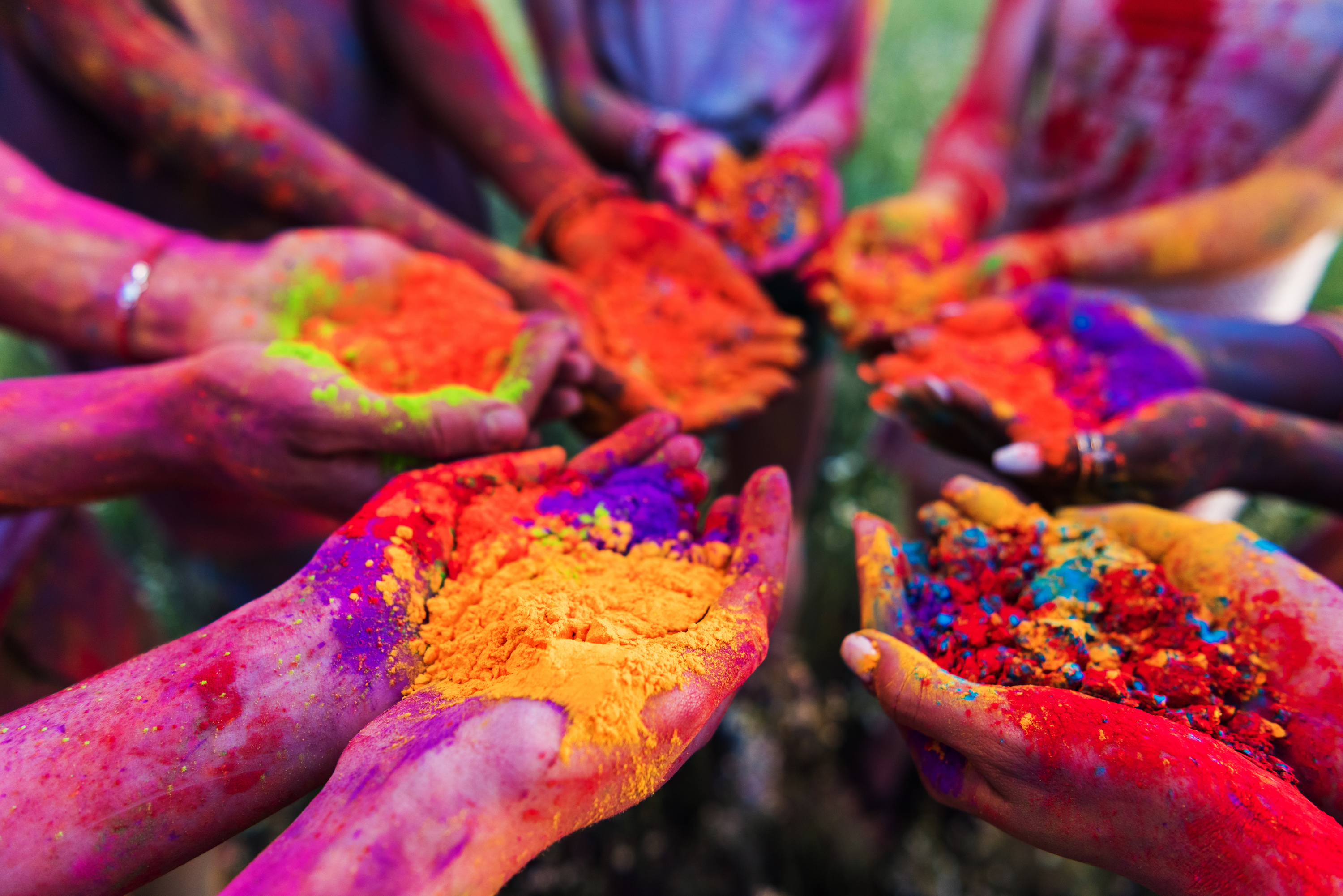 Hands holding colour pigment