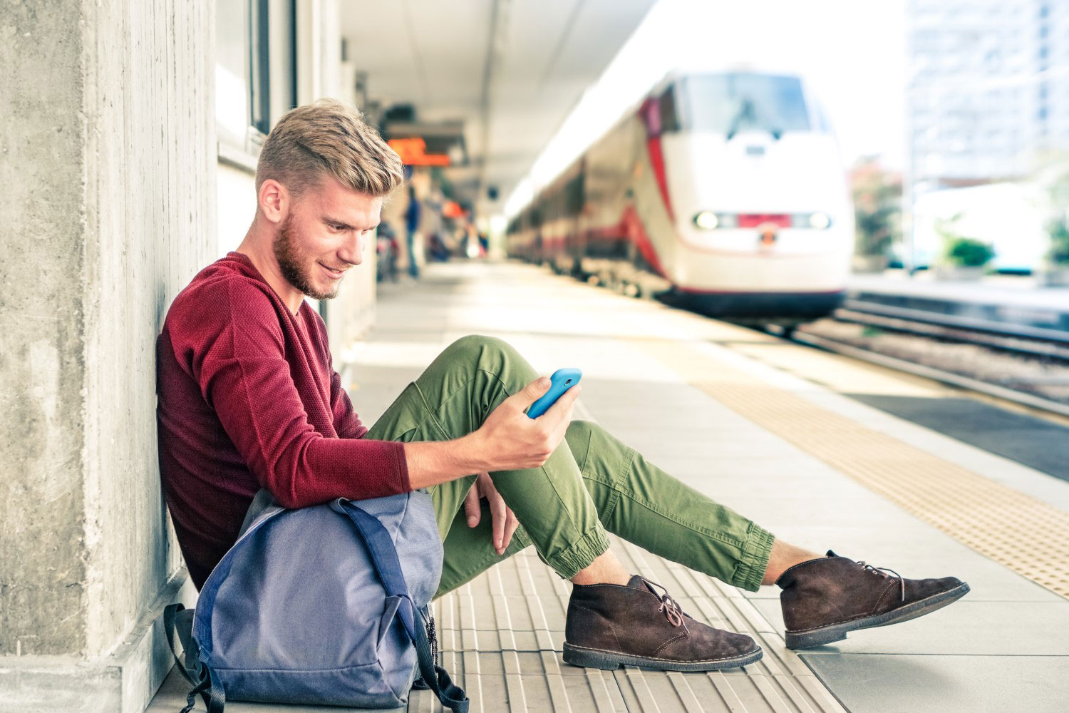 Man using phone at train station