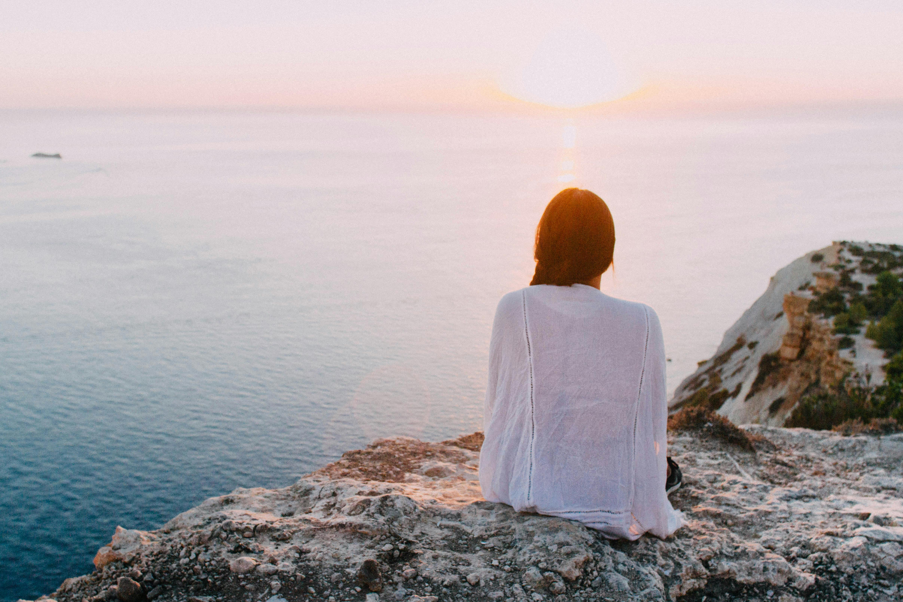 Girl sat overlooking the ocean