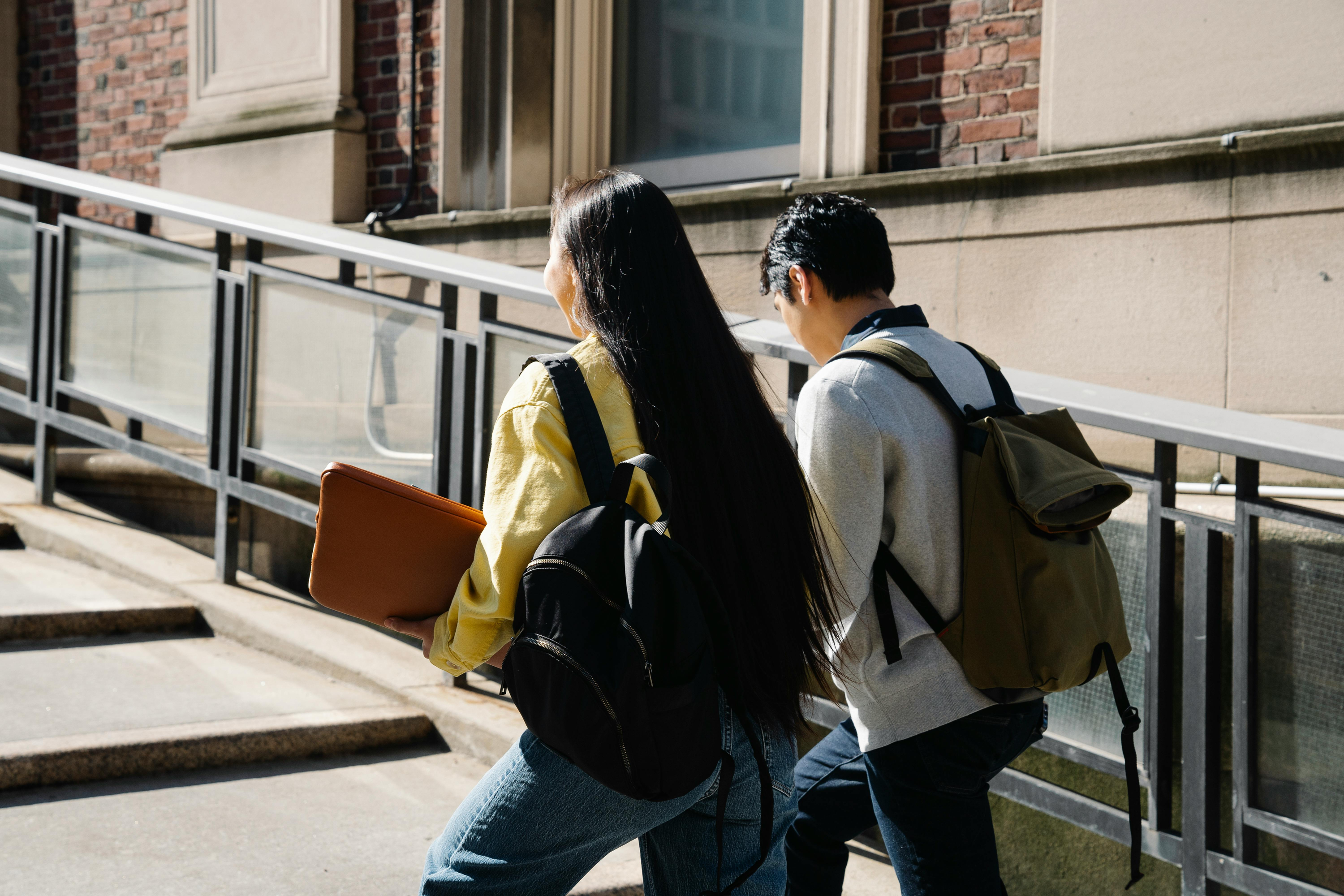 Girl and boy walking up steps