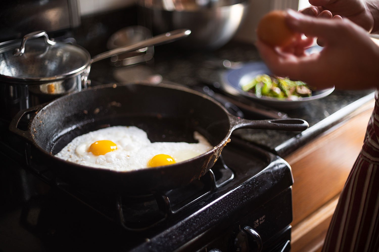 Eggs cooking on the hob in frying pan