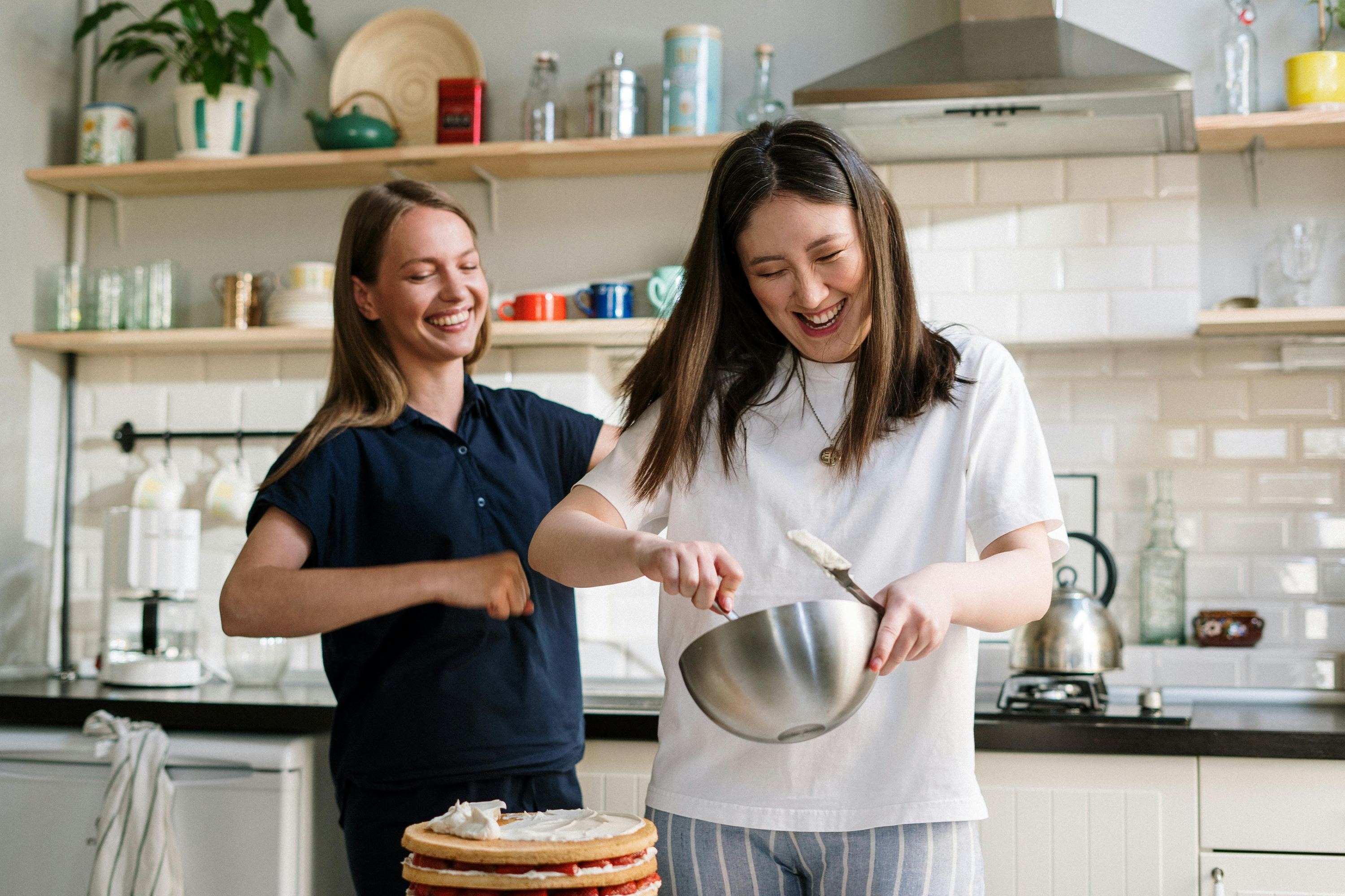 Two friends cooking in the kitchen