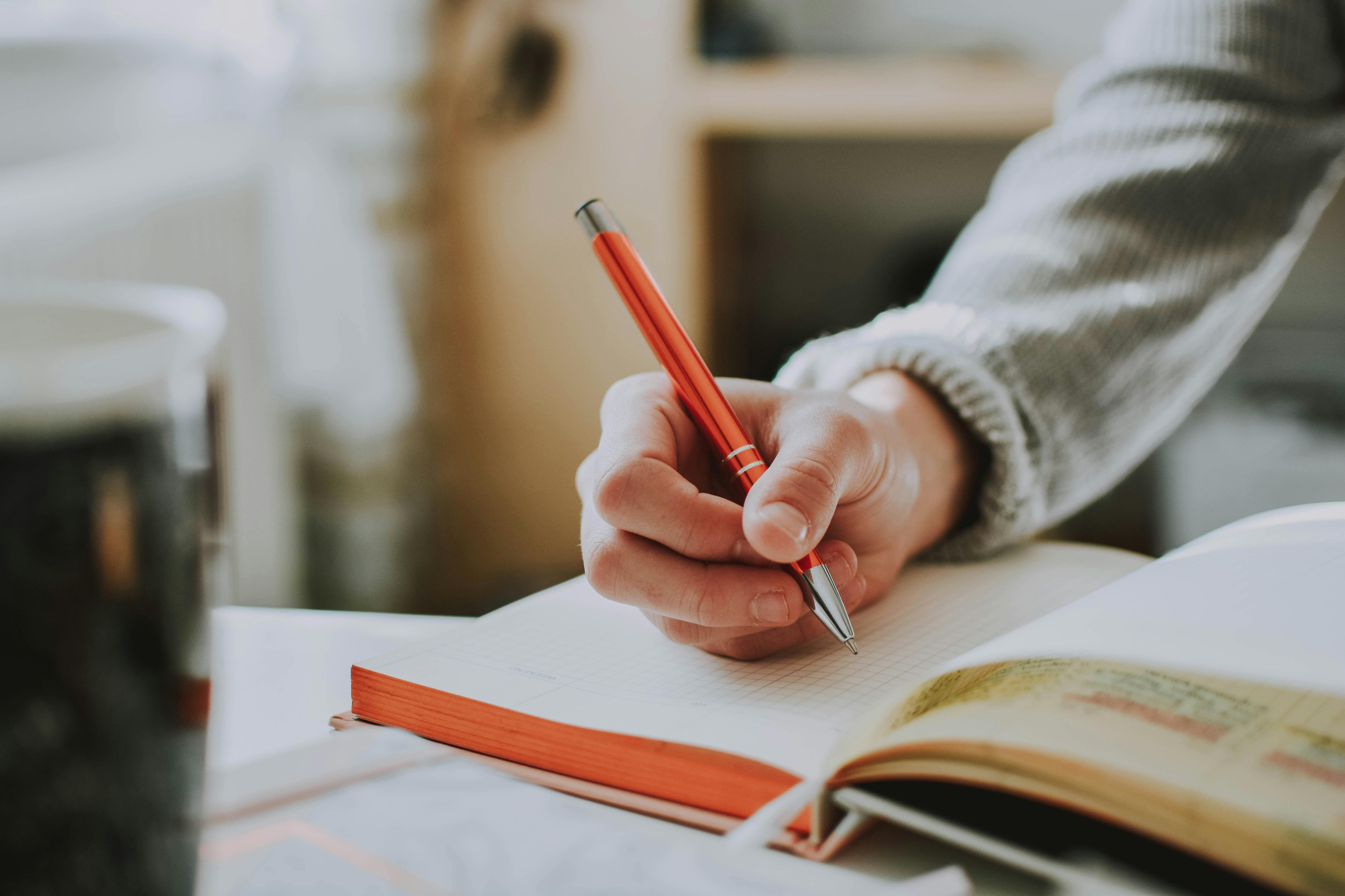 Student writing in notebook 
