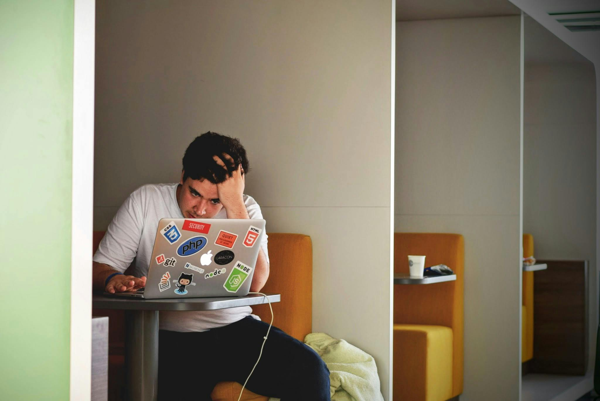 Stressed boy sat in front of laptop