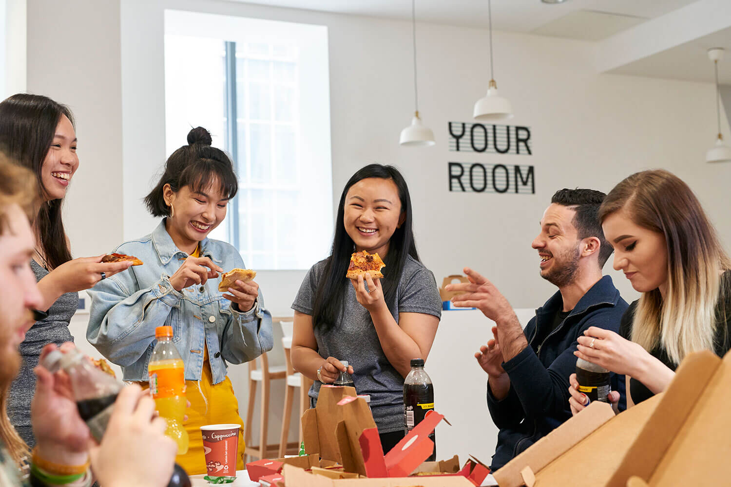 Students eating pizza in the common room