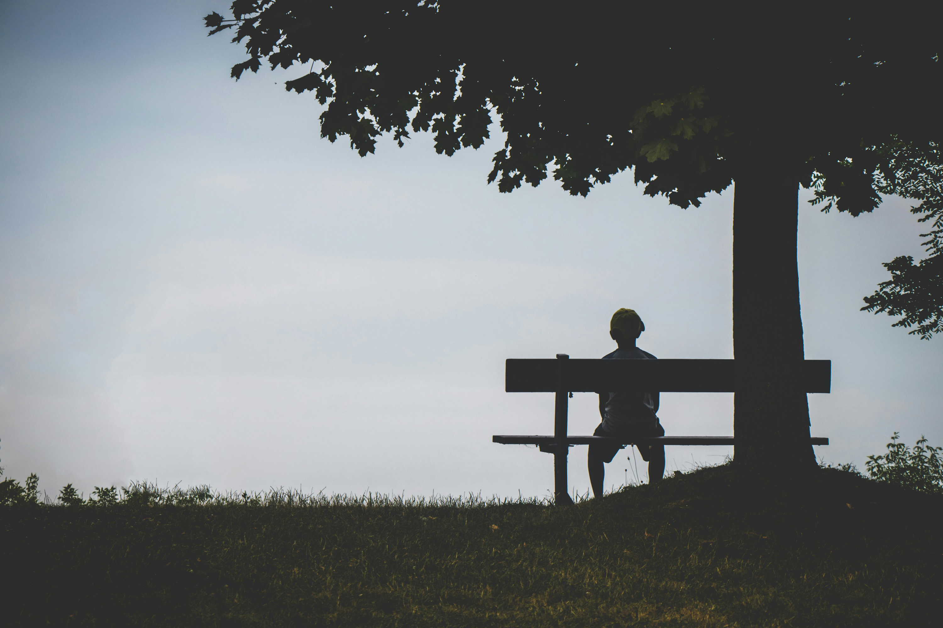 Person sitting on bench alone