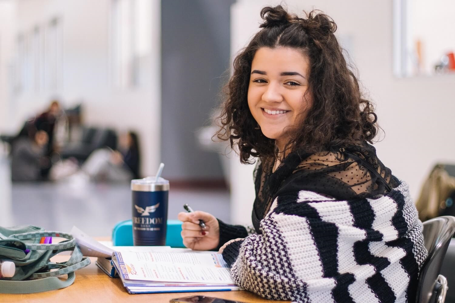 Young woman smiling and studying