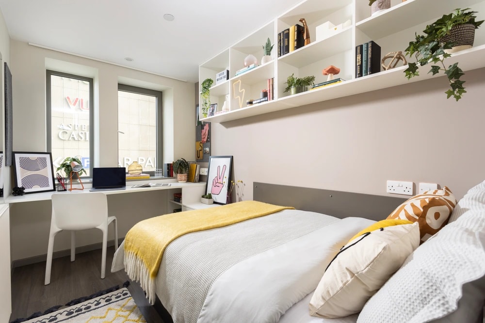 Bed and desk in an ensuite room