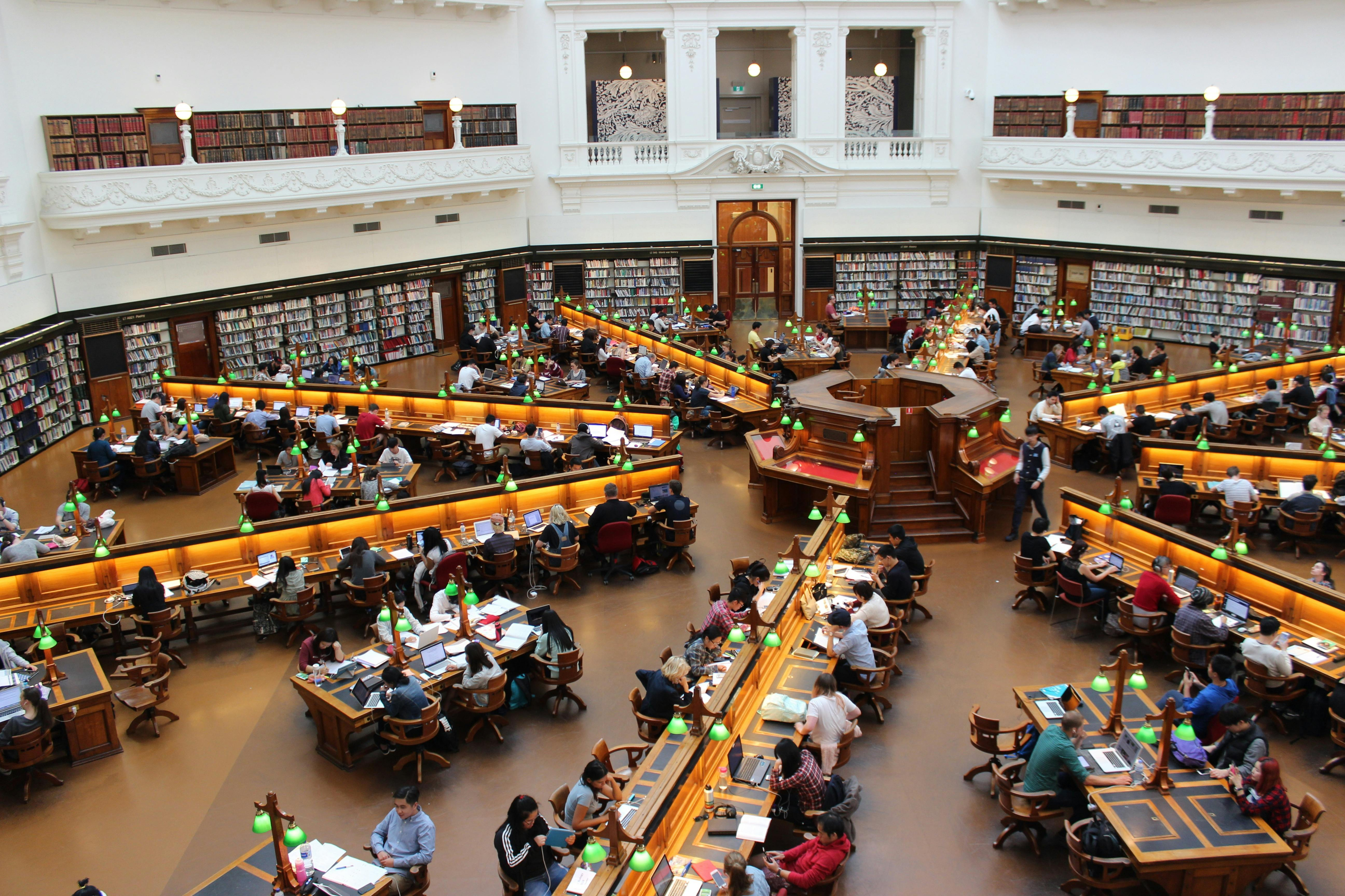 People at desks in library