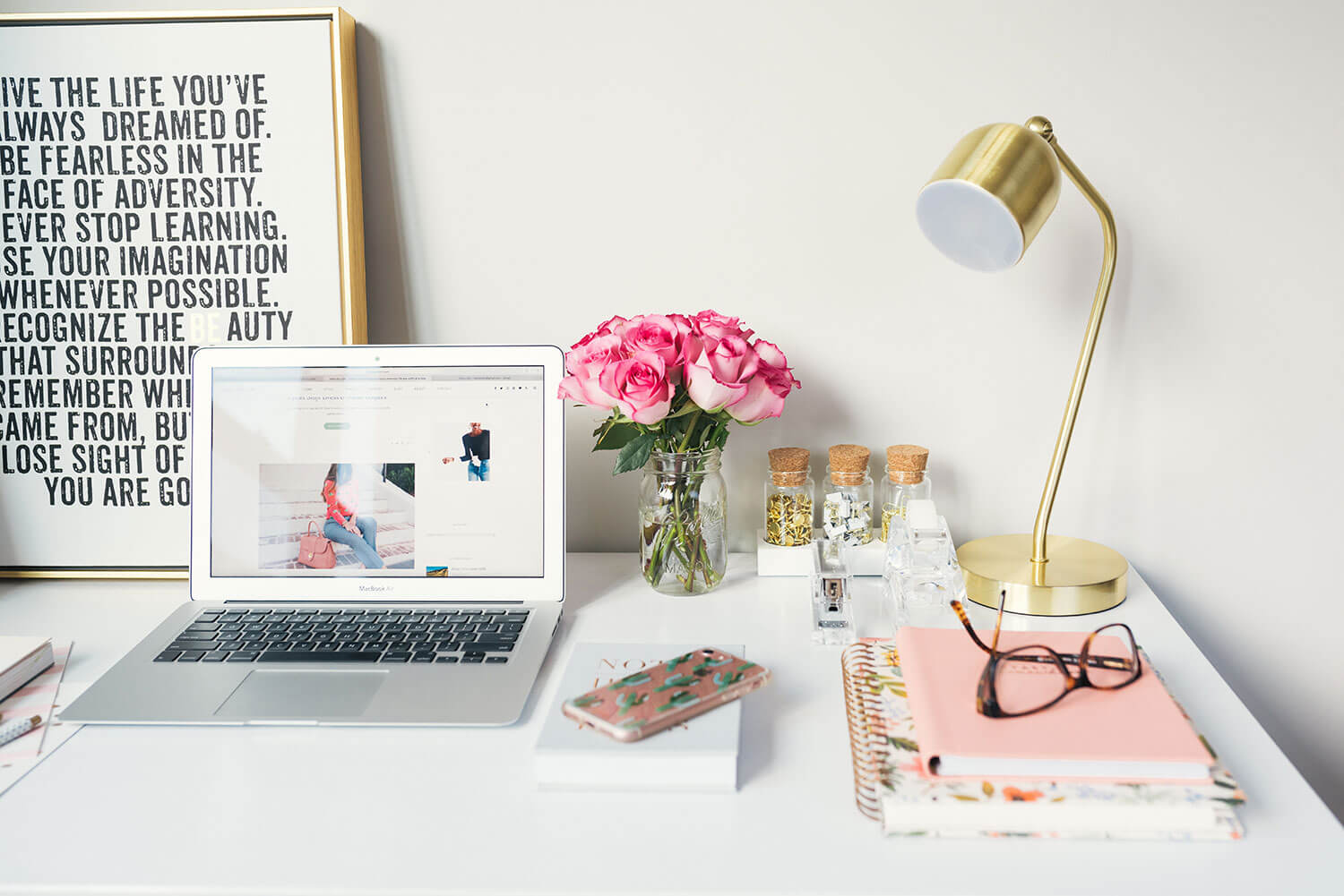 Photo of desk with stationary and laptop