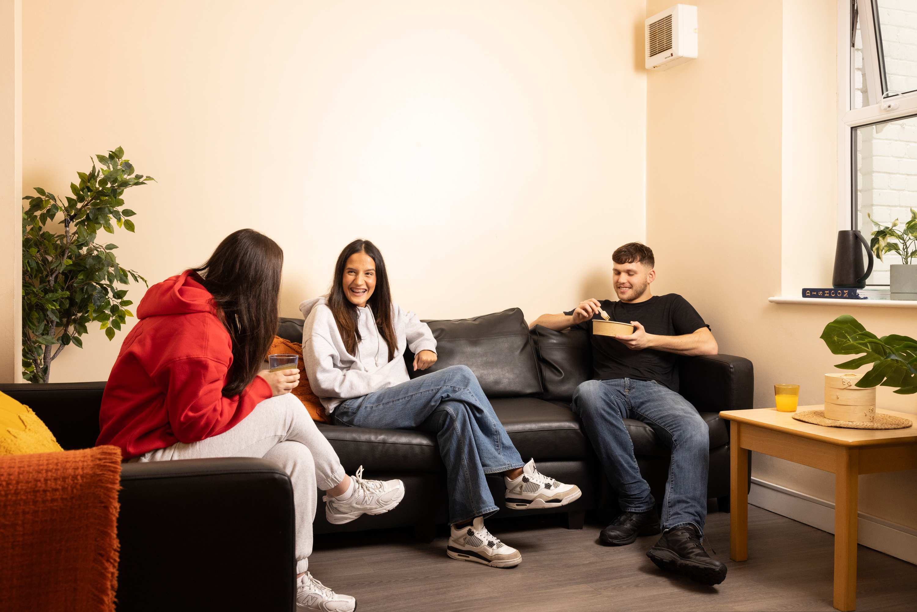 Students in seating area shared kitchen