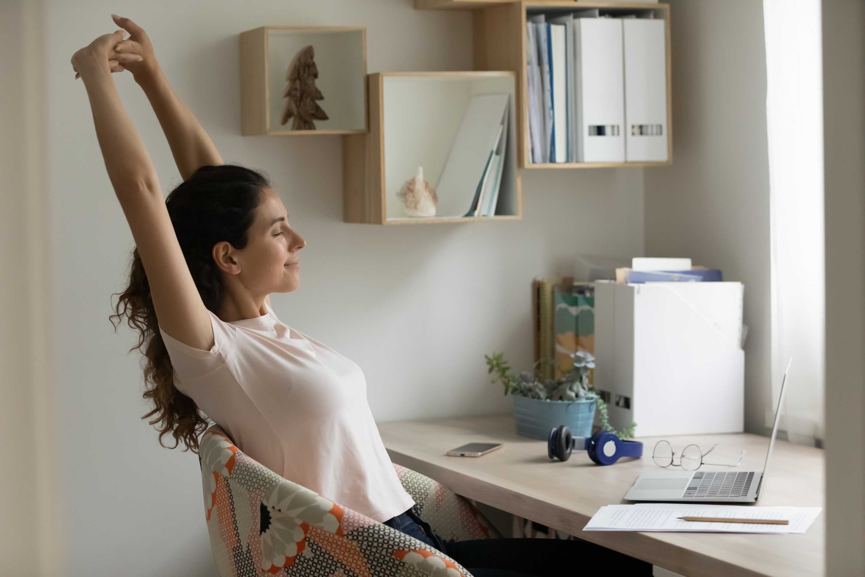 Image of woman stretching at desk