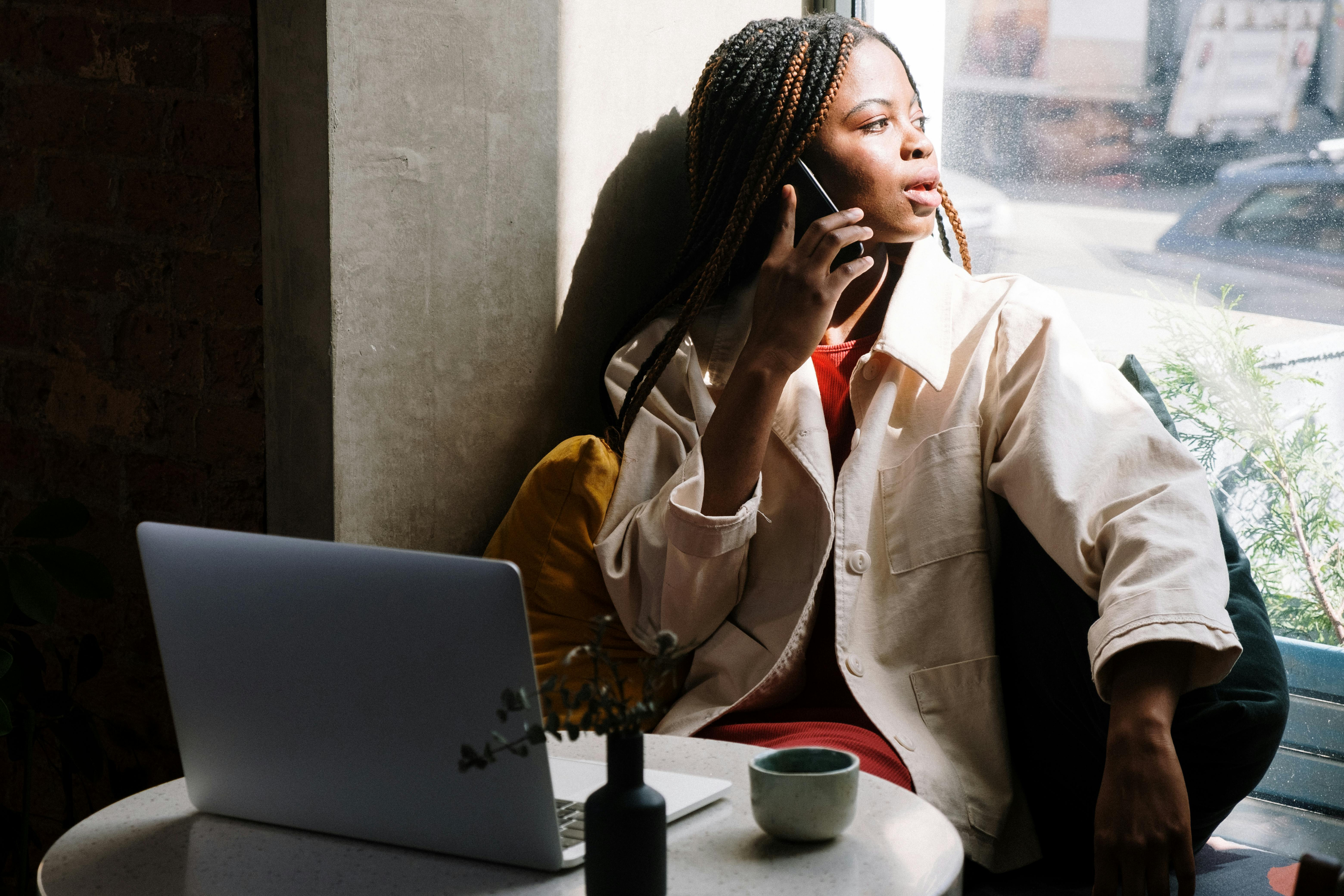 Student in front of laptop on the phone