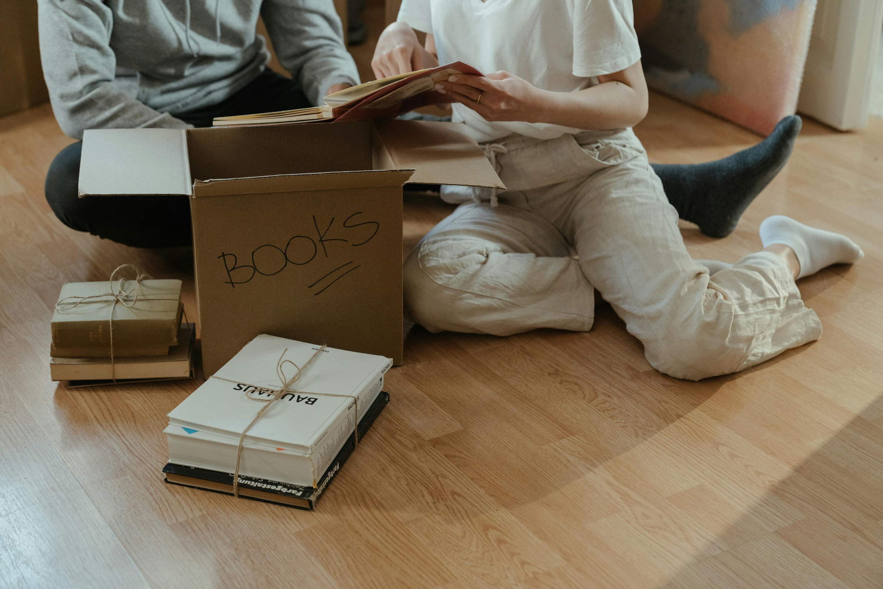 People sat on the floor unpacking boxes